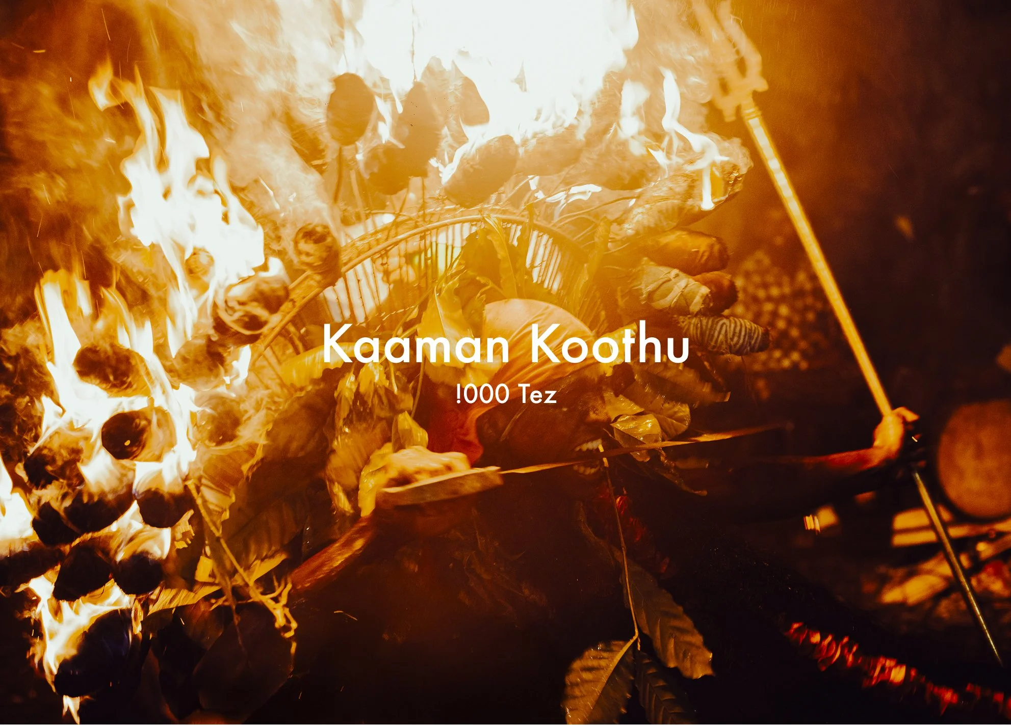 A person performing with fire and a large flaming grill in the background, dressed in traditional attire with a headdress, during a cultural fire show.