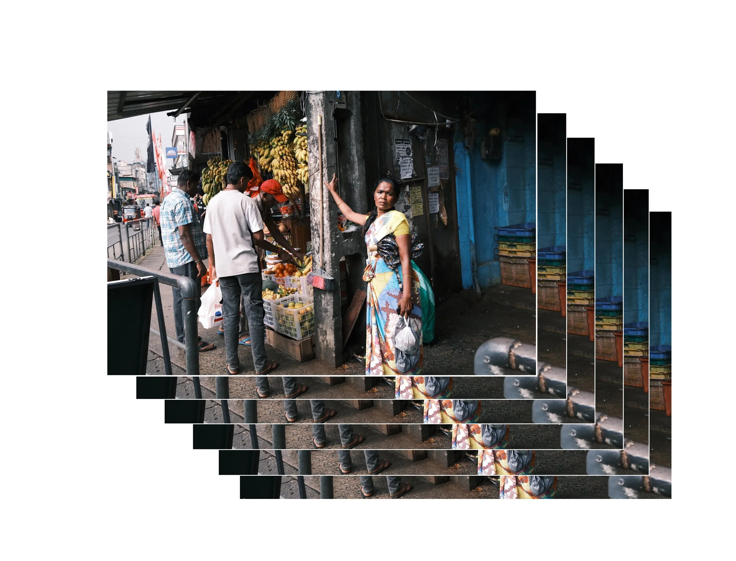 A street market scene with a woman in a sari, and three men buying fruit from a small stall selling bananas and oranges in an urban area.