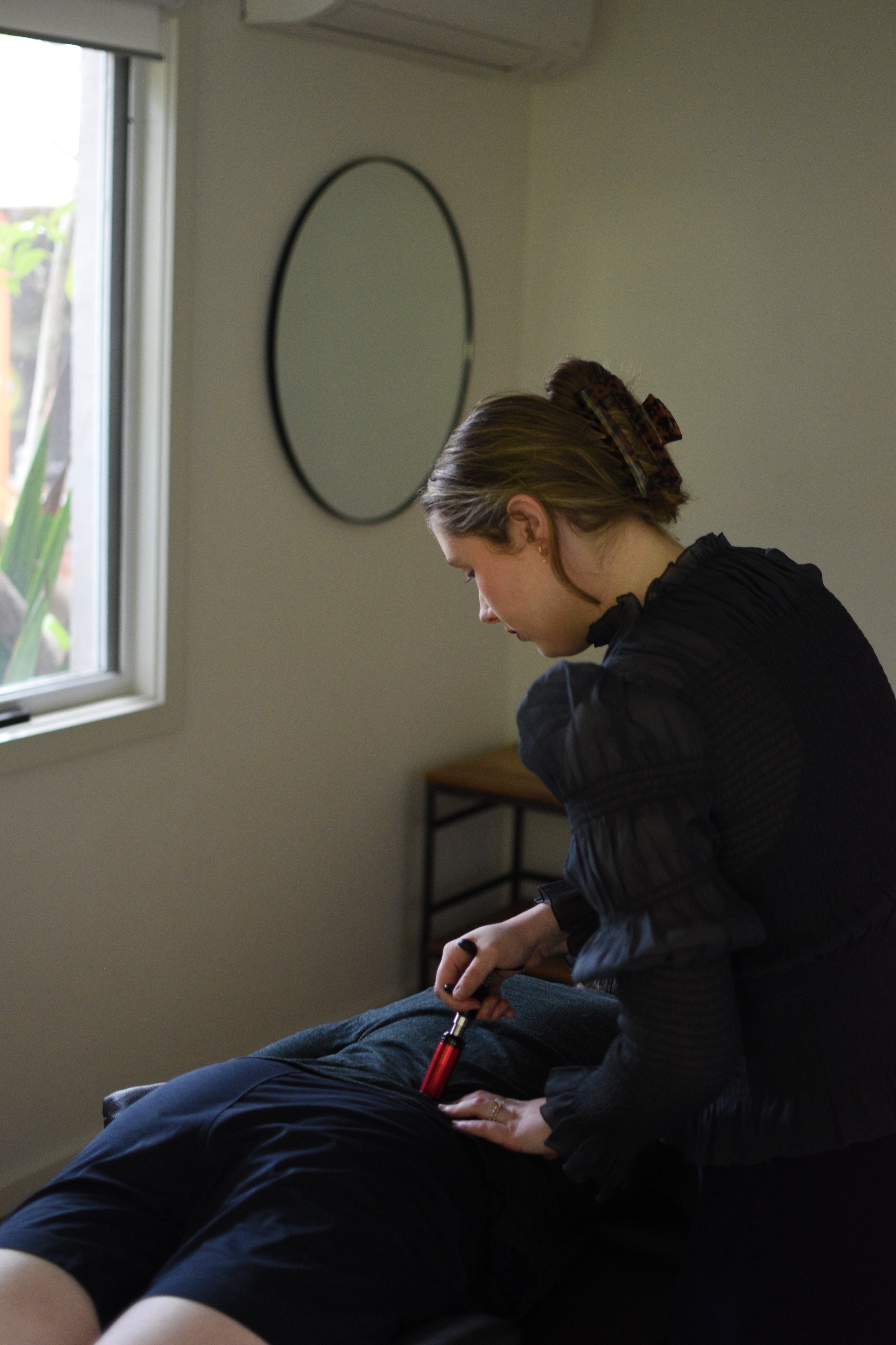 Dr Florence Drummond, a chiropractor in Ocean Grove, Victoria, Australia, assessing a patient from Geelong , the Bellarine and Ocean Grove / Barwon Heads / Point Lonsdale region, with back pain, neck pain, pins and needles