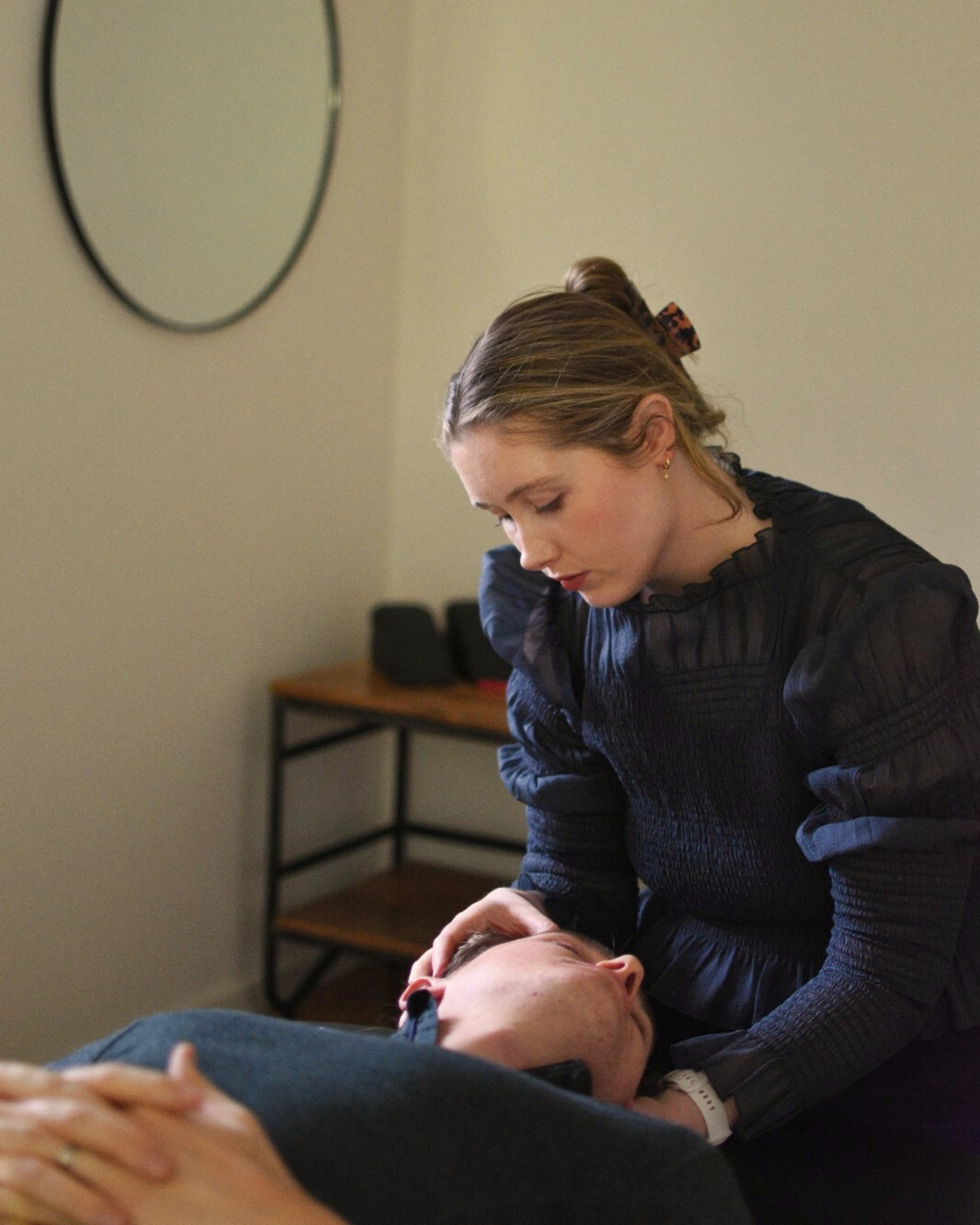 Dr Florence doing soft tissue and massage on a patient with a neck adjustment and doing cranial therapy to help with neck pain, migraines, headaches, soreness, tightness, shoulder pain, back pain and tension, poor sleep and stress