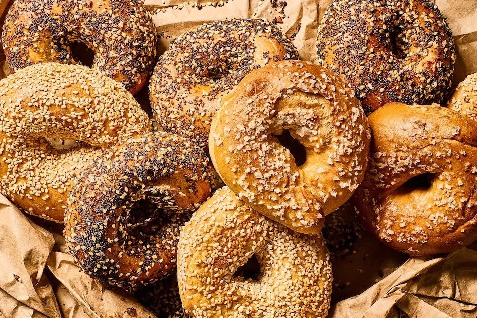 Assorted bagels topped with sesame, poppy seeds, and other toppings