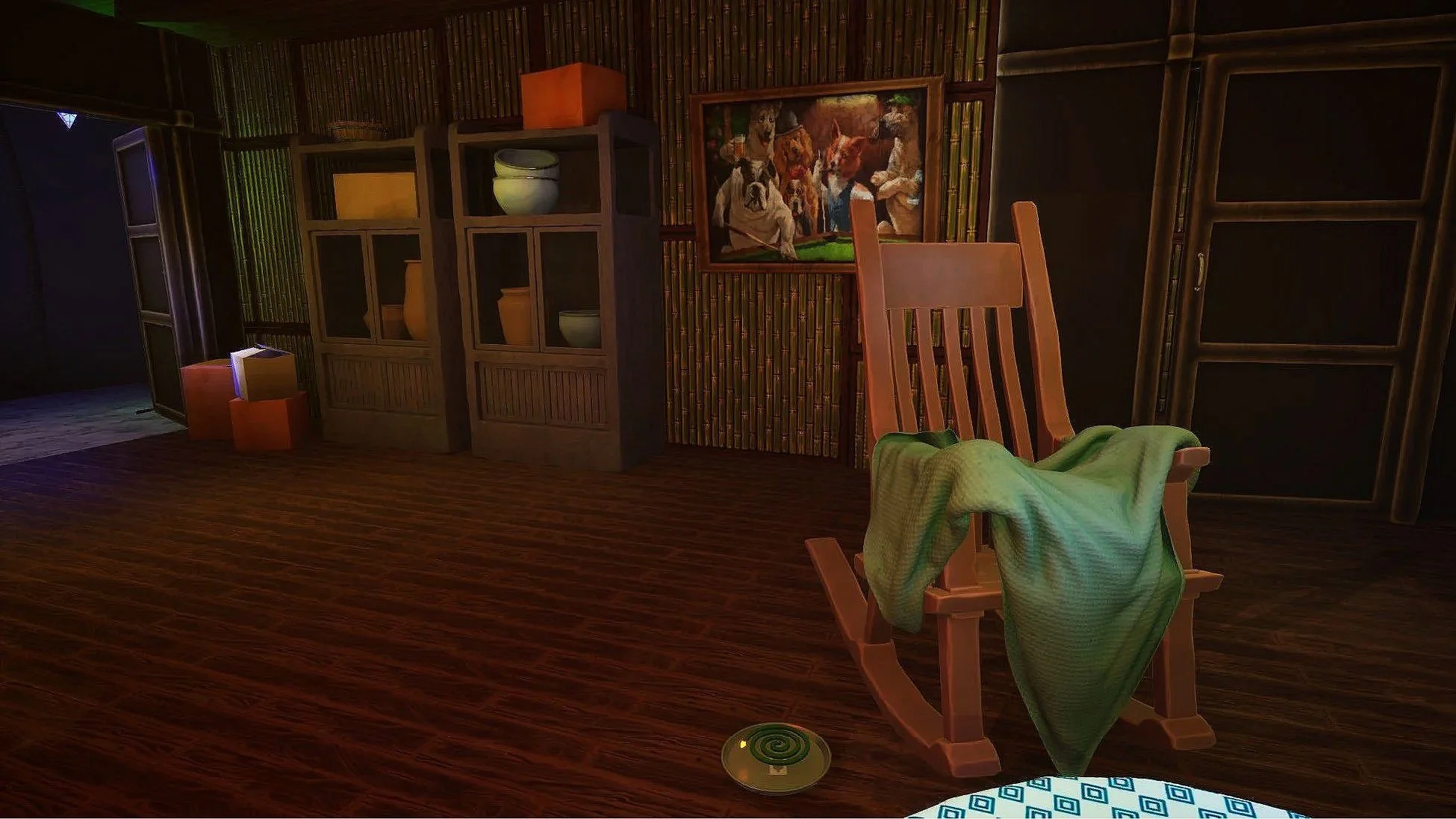 A rocking chair with a green blanket draped over it in a room with wood floors, a bookcase with vases and bowls, a framed dog painting on the wall, and a green spiral decorative item on the floor.