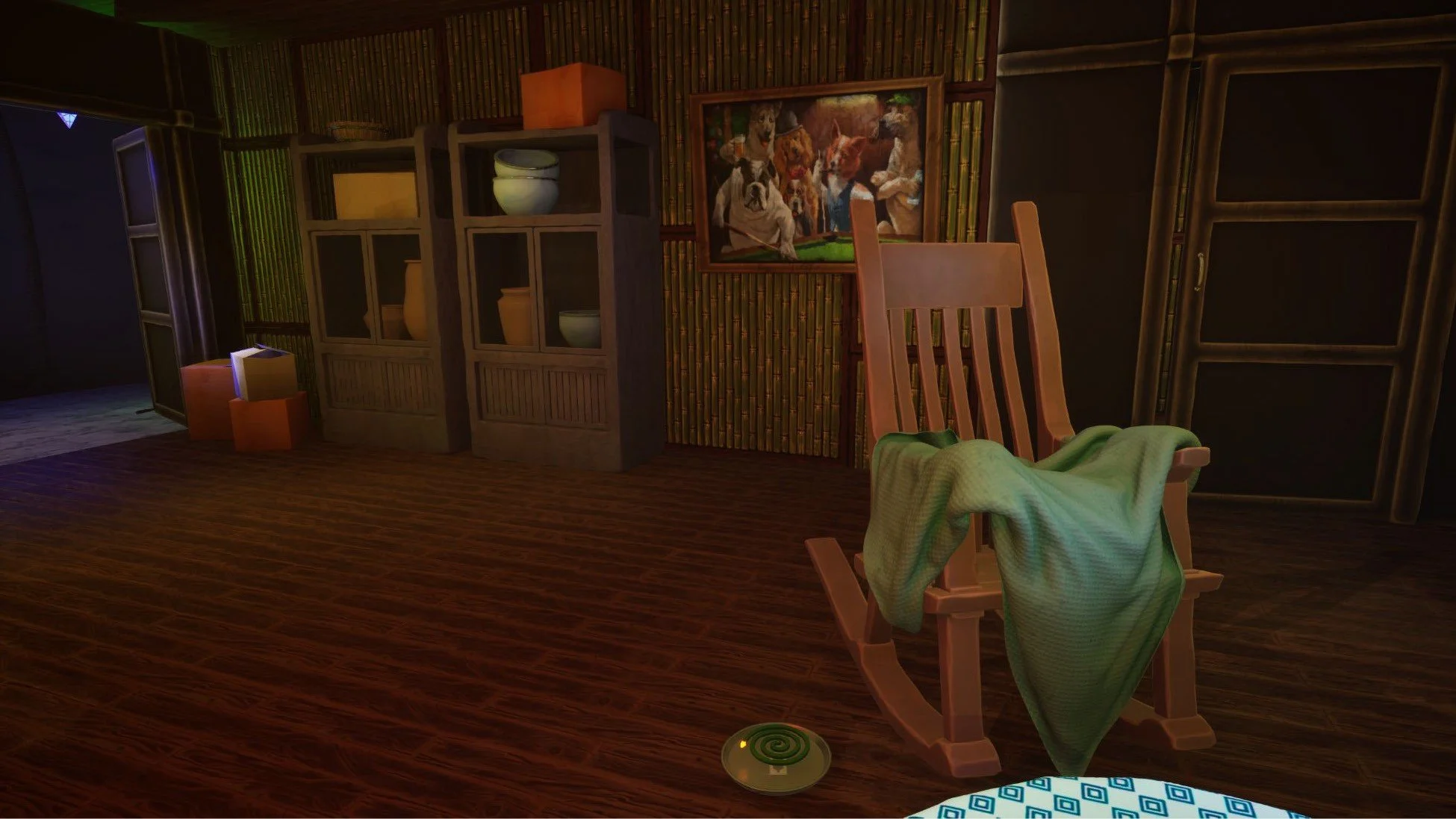 A rocking chair with a green blanket draped over it in a room with wood floors, a bookcase with vases and bowls, a framed dog painting on the wall, and a green spiral decorative item on the floor.