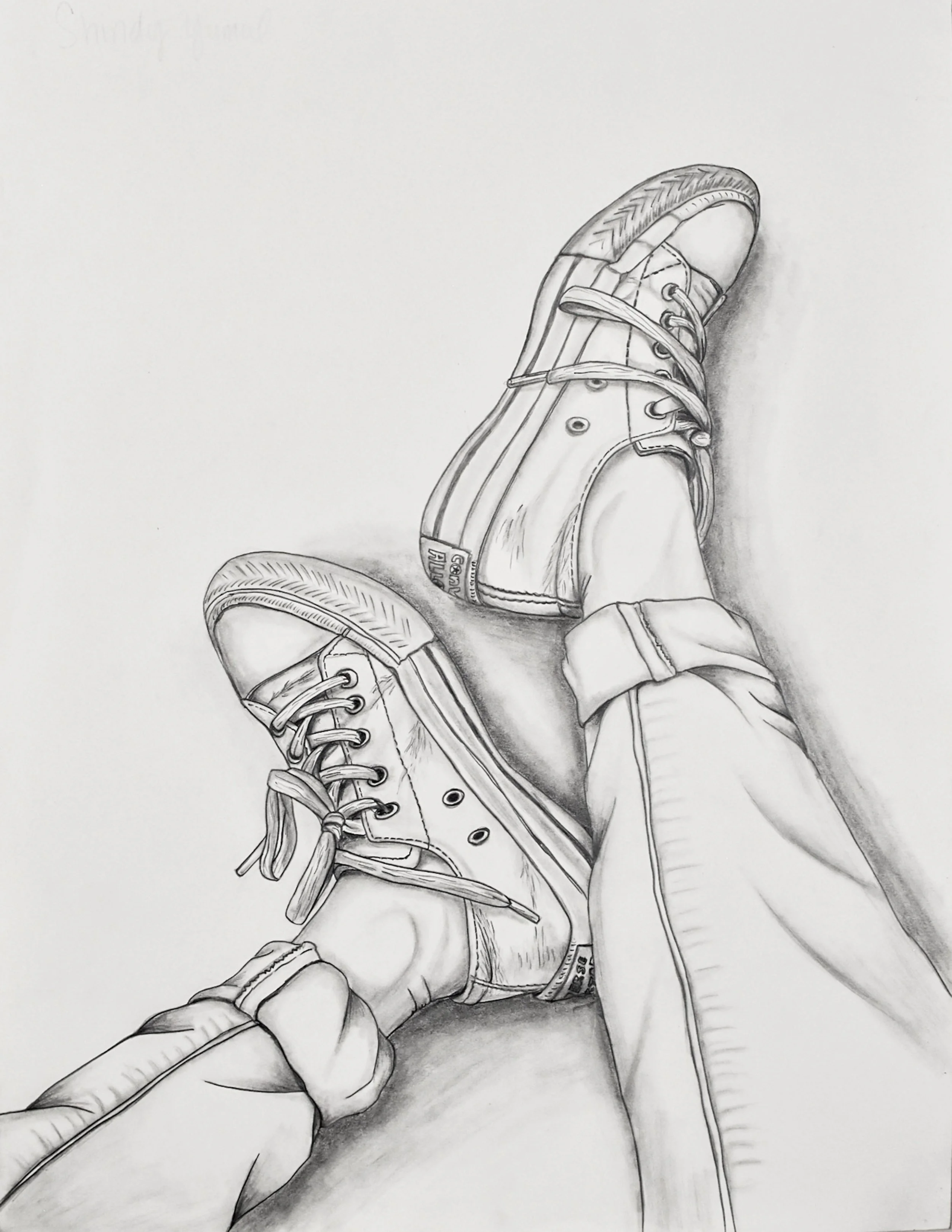 Sketch of a person's legs and feet wearing sneakers, with the feet crossed and resting on a flat surface.