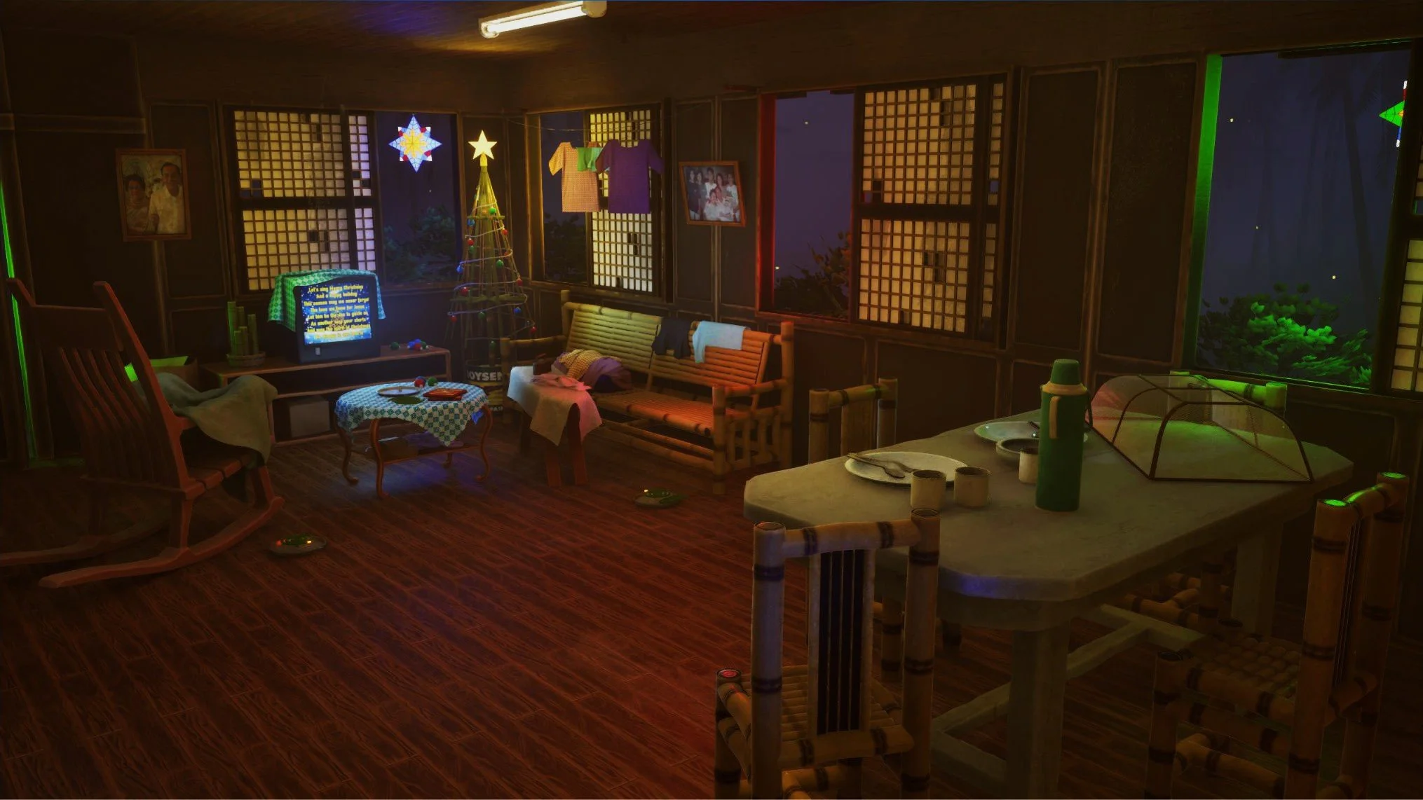 Living room decorated for Christmas with a Christmas tree, hanging clothes, a rocking chair, a coffee table, a TV, and a dining table with chairs, illuminated by warm lighting.