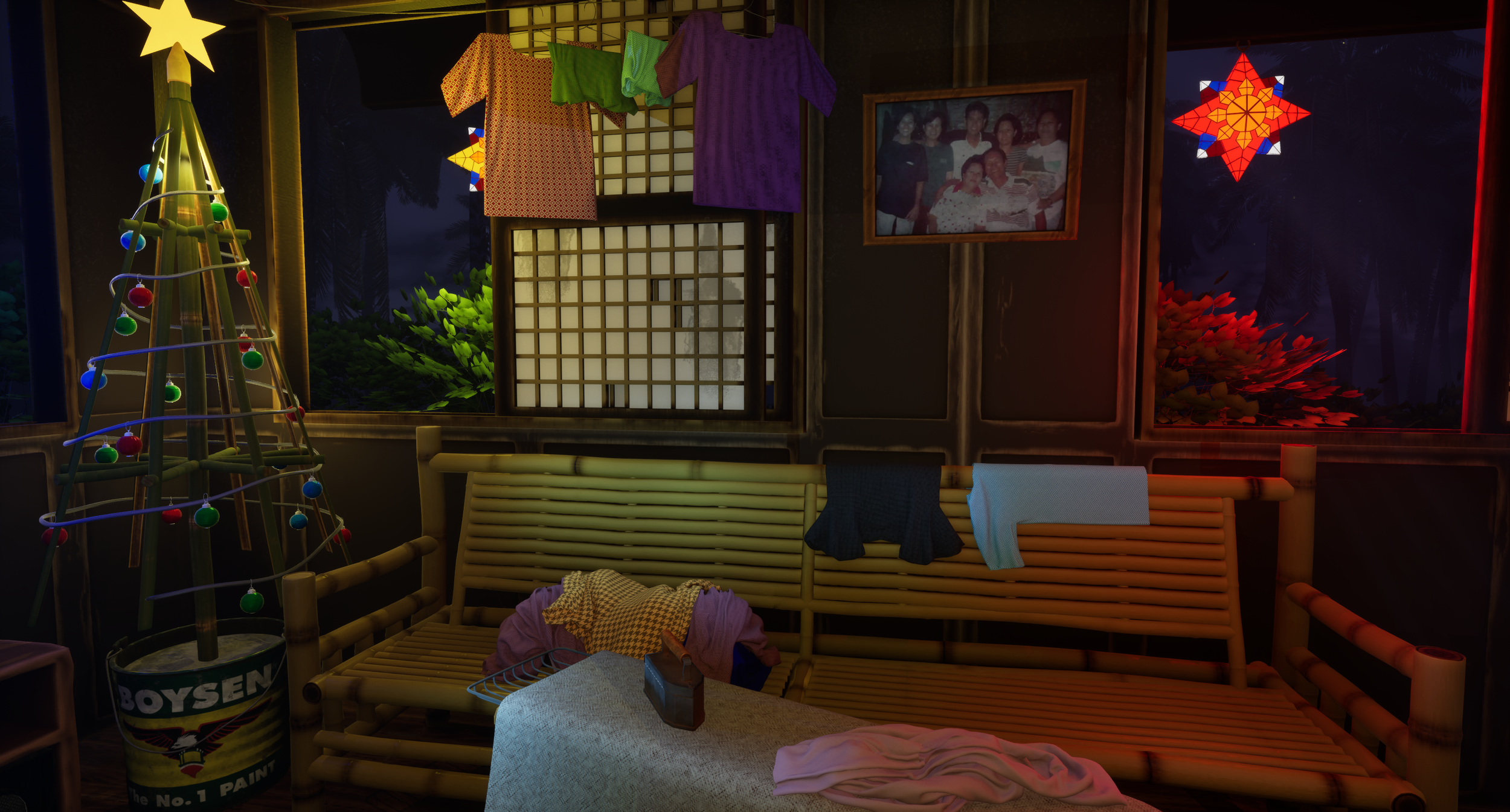 A festive room decorated with a small lit Christmas tree, colorful paper lanterns, hanging clothes, a framed family photo, and paper star lanterns, with a bamboo-style sofa and a table with clothes and a bottle.