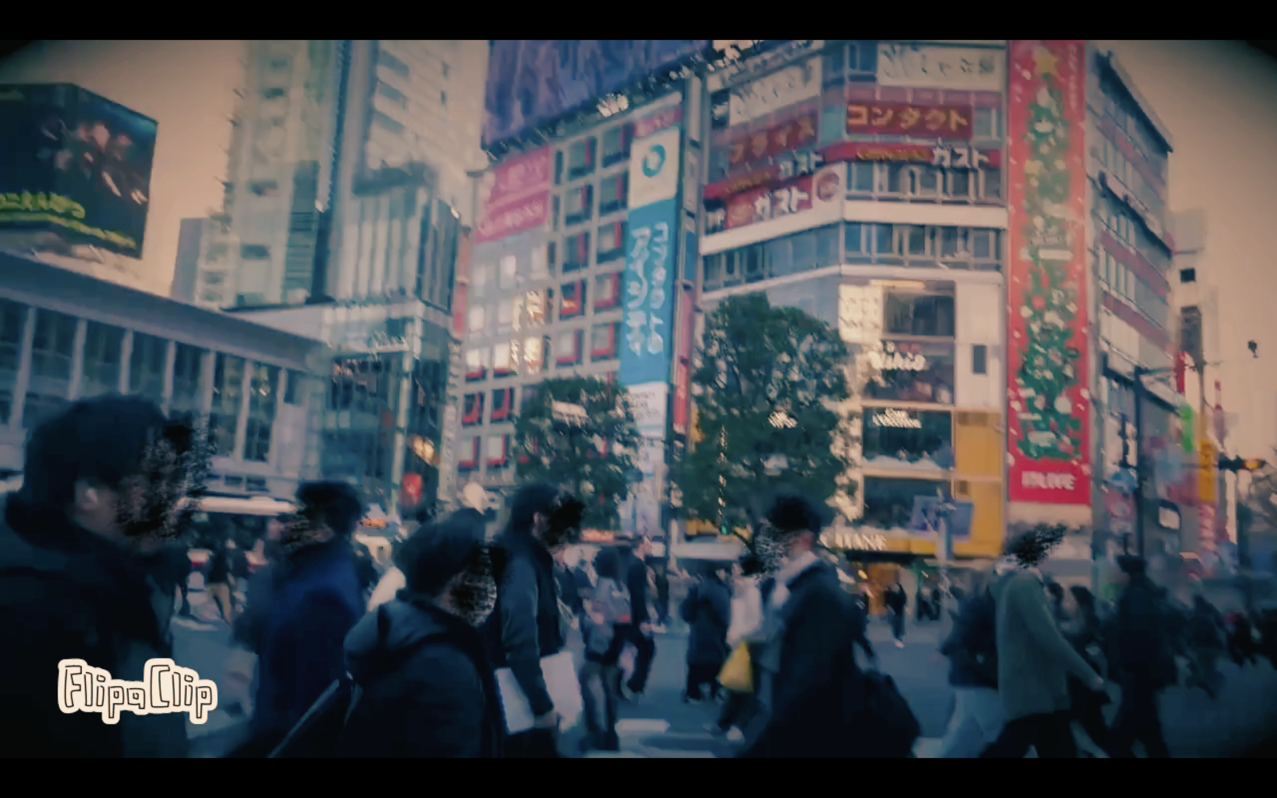 Urban scene with busy crosswalk filled with pedestrians in a city, tall buildings with colorful signs and advertisements, and a large digital billboard.