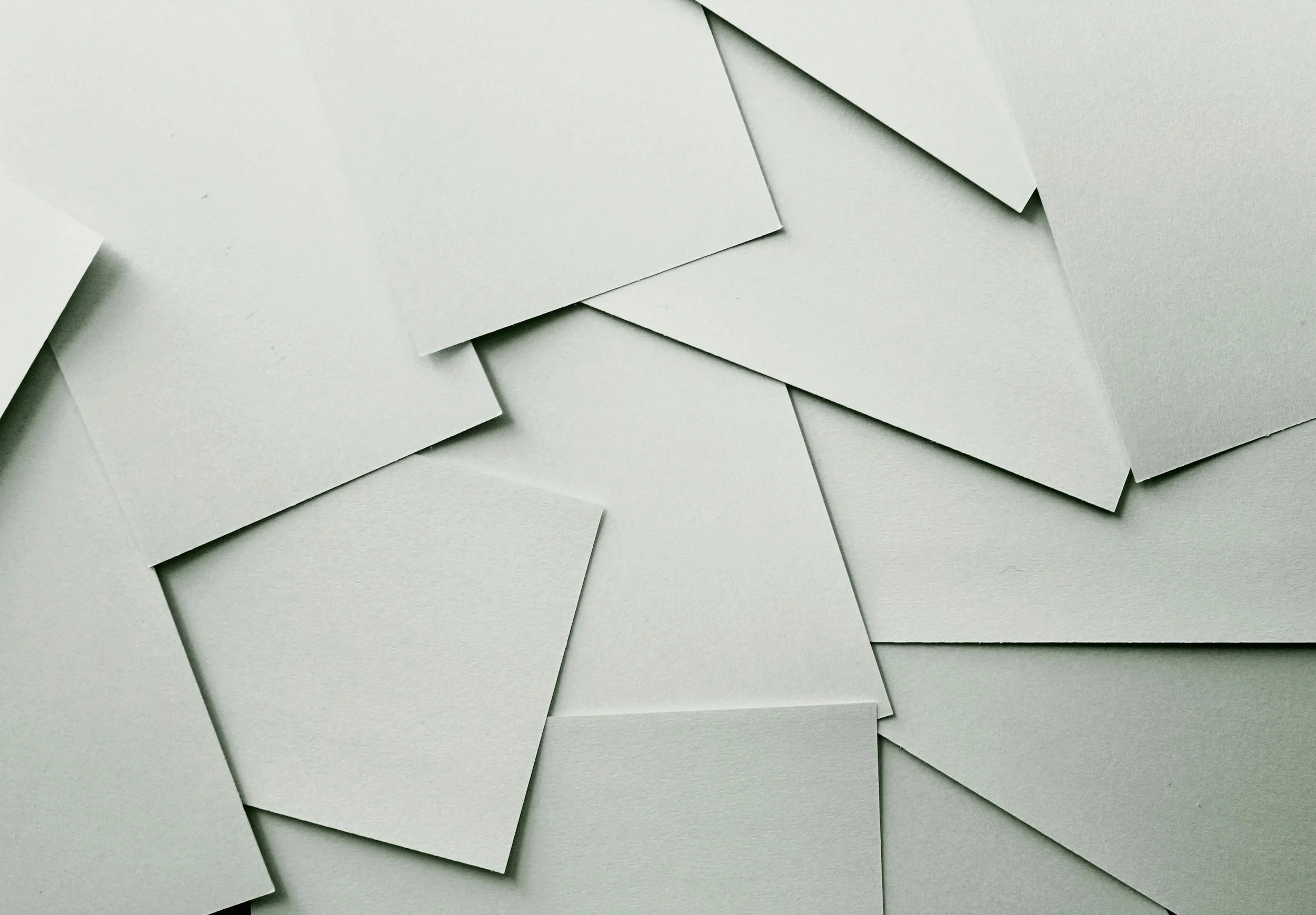 Overlay of white paper sheets scattered and layered