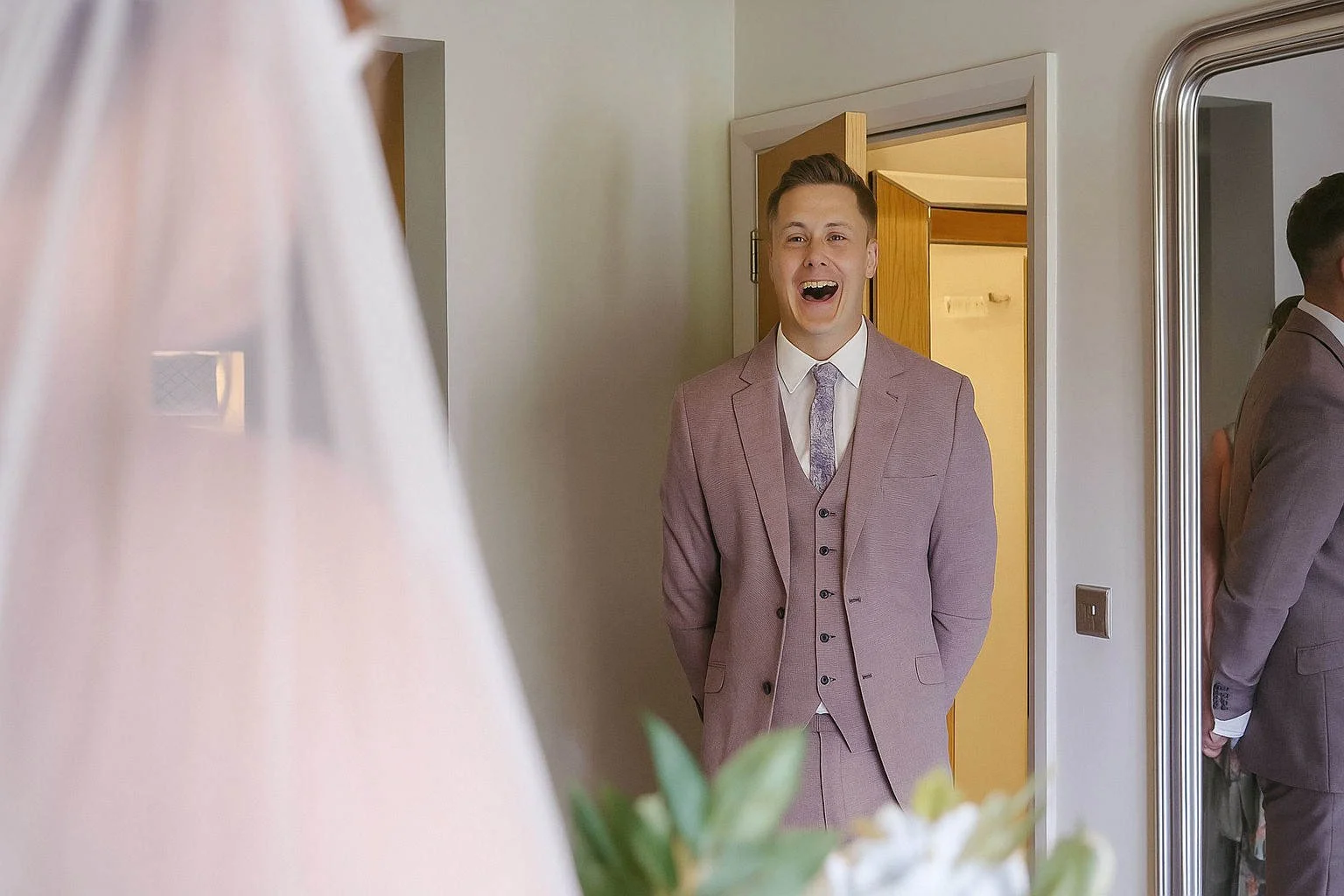 Groom reacts with joy during first look at bride at The White Hart Inn