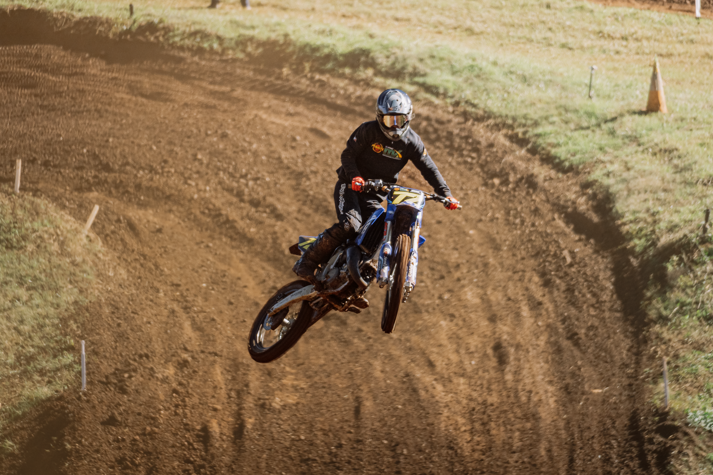 A person riding a dirt bike on a dirt track.