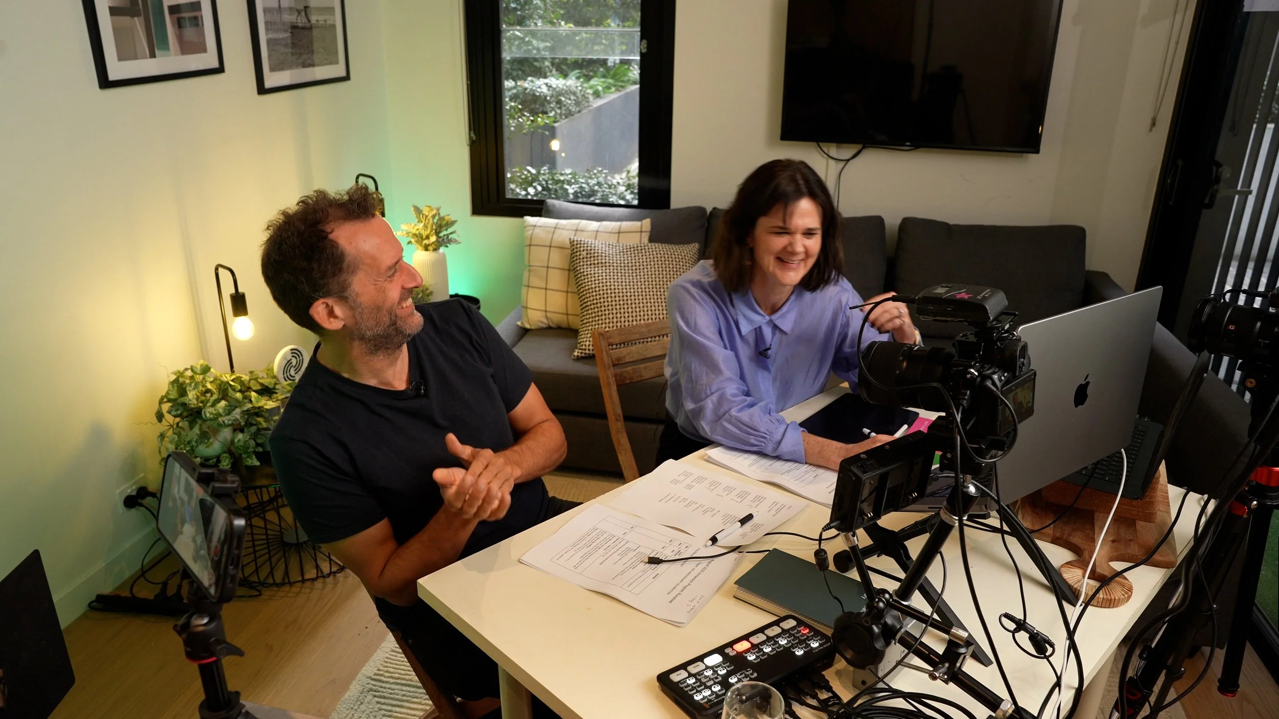 Penny Terry and Cam Fink hosting an online conference with recording equipment, cameras and lights. 
