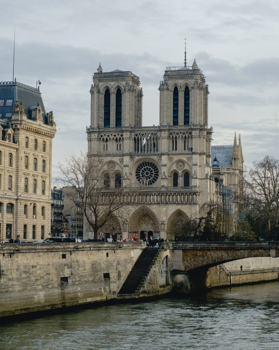 Notre-Dame cathedral's twin towers seen across the Seine and a stone bridge