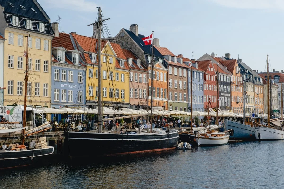 Nyhavn's row of colorful gabled houses with wooden sailing ships docked along the canal