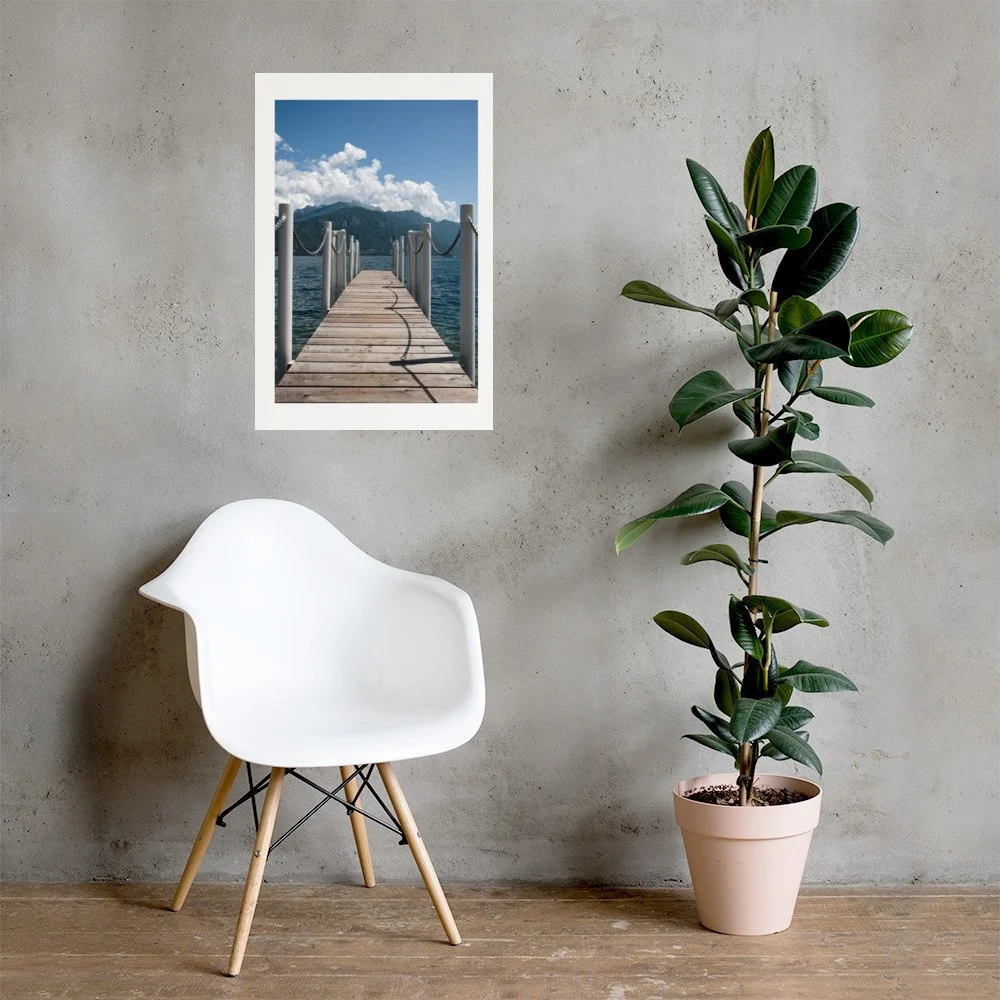 Minimal lake landscape print featuring a wooden pier extending toward alpine mountains under blue skies. Calm, modern nature wall art.