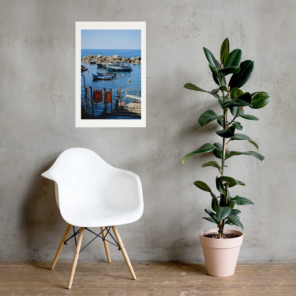 Italian coastal wall art featuring boats anchored in Riomaggiore harbor. Bright Mediterranean seaside photography.