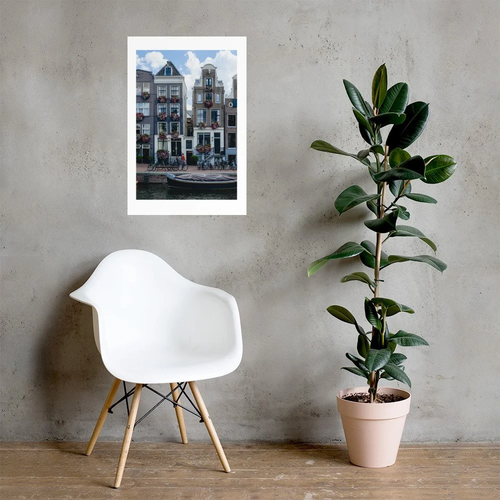 Amsterdam canal houses wall art print featuring historic Dutch architecture with colorful summer flowers. European city photography for elegant interiors.