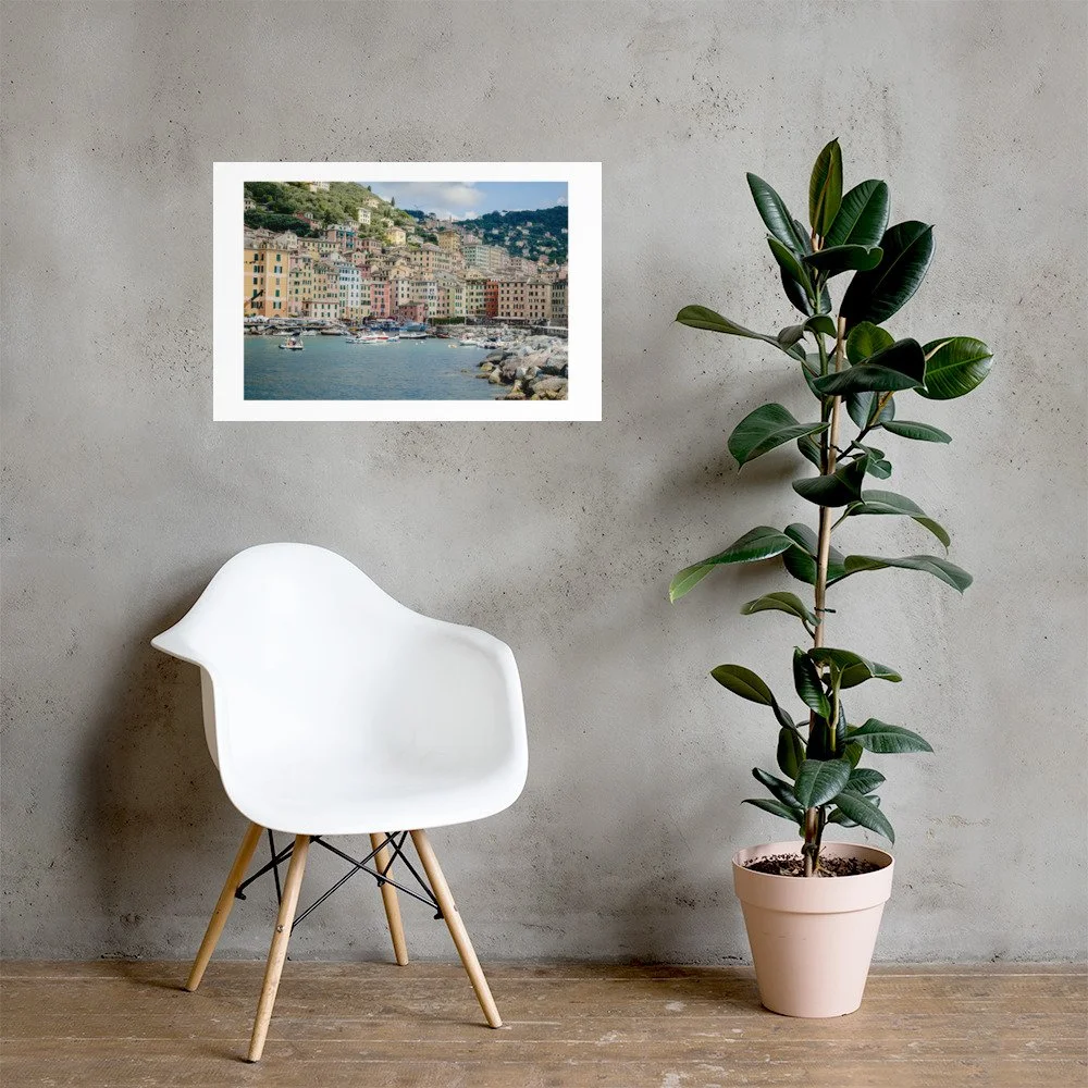 Italian Riviera wall art print featuring the pastel harbor of Camogli. Mediterranean coastal photography with boats, colorful buildings, and warm summer light.