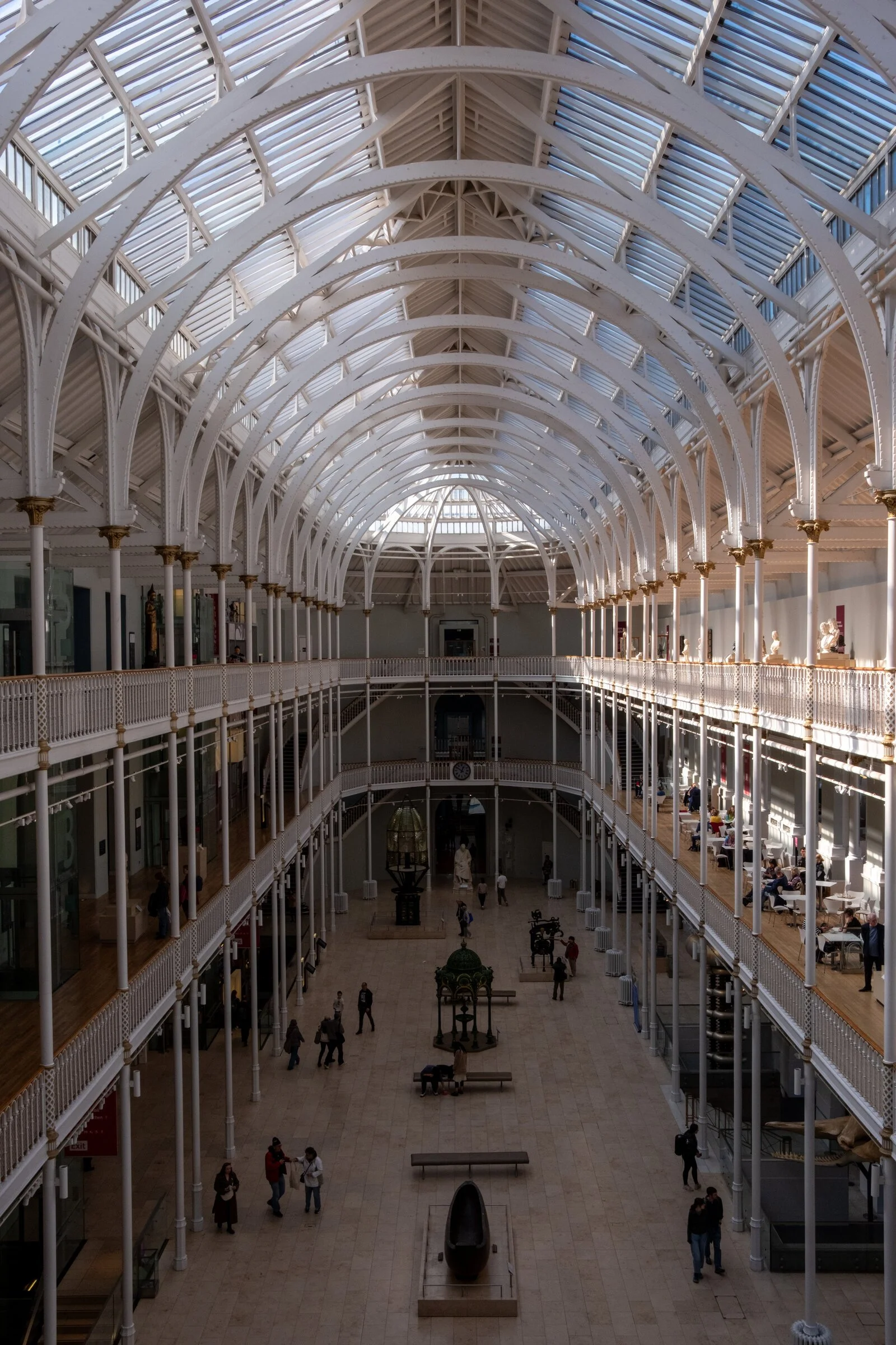 Sweeping arched galleries of glass and iron inside the National Museum of Scotland's Grand Gallery