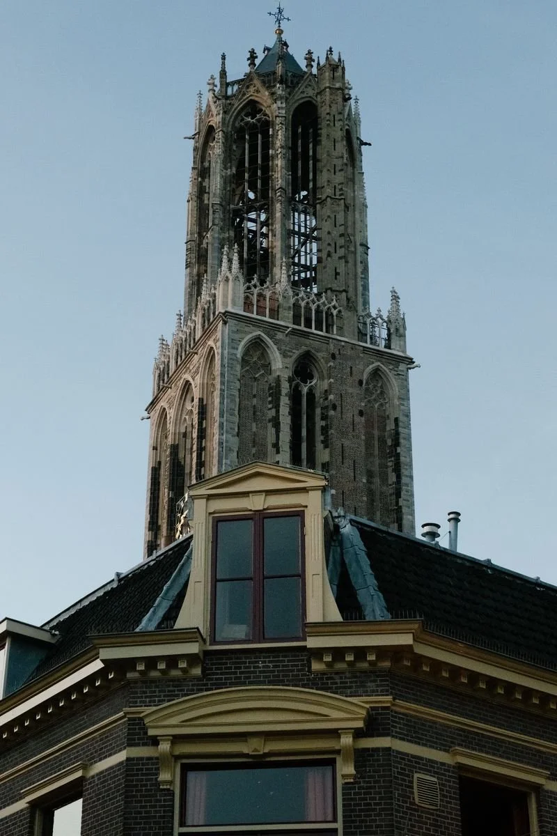 Utrecht's Dom Tower rises above a gabled rooftop