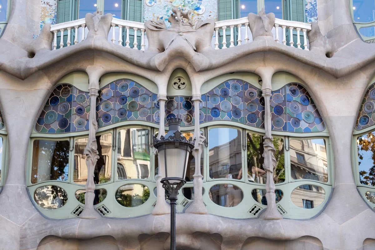 Casa Batllo's bone-like facade curves around stained-glass windows and a wrought-iron balcony
