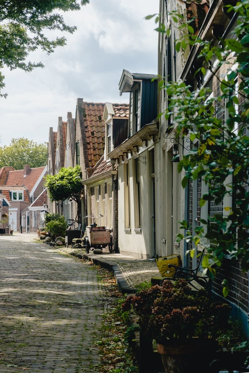 A cobbled lane runs through a village of gabled Dutch cottages