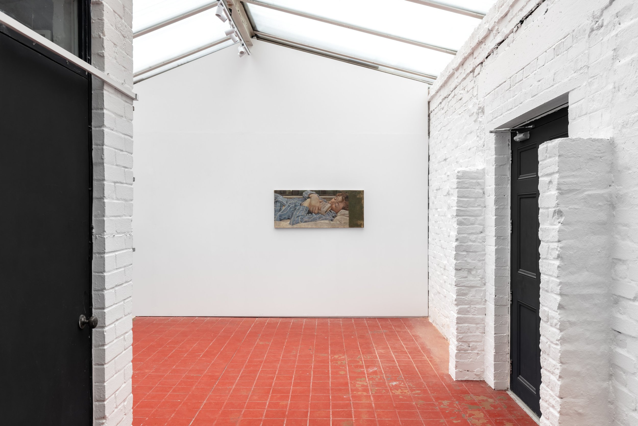 Image of one portrait in oil paint hanging in a gallery space with white walls and a red floor