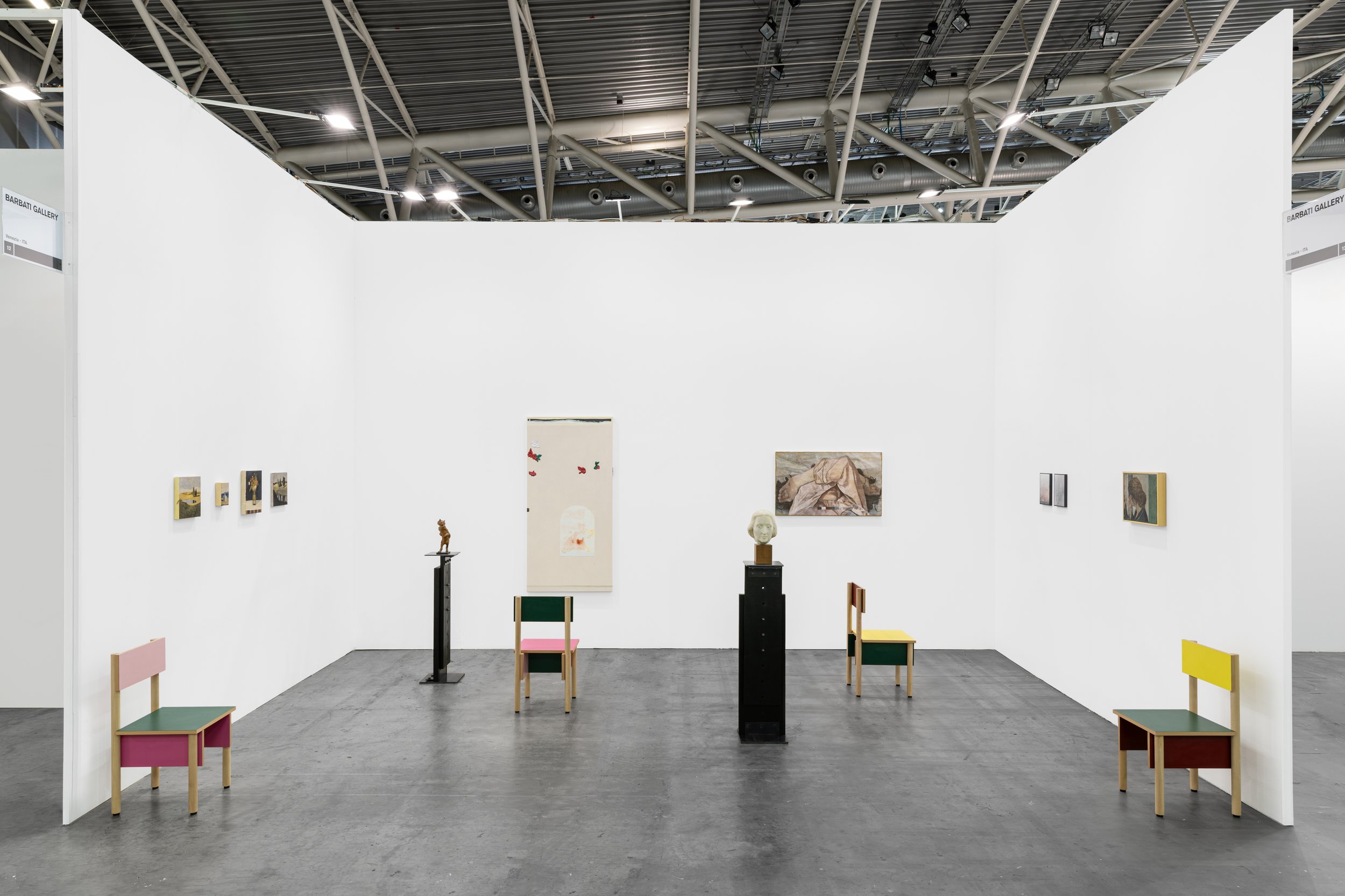 Image featuring an exhibition of paintings and sculptures at the Turin art fair Artissima.