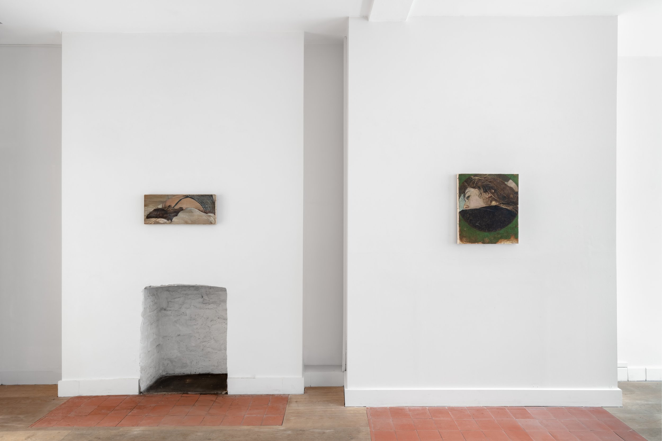 Image of two portraits in oil paint hanging in a gallery space