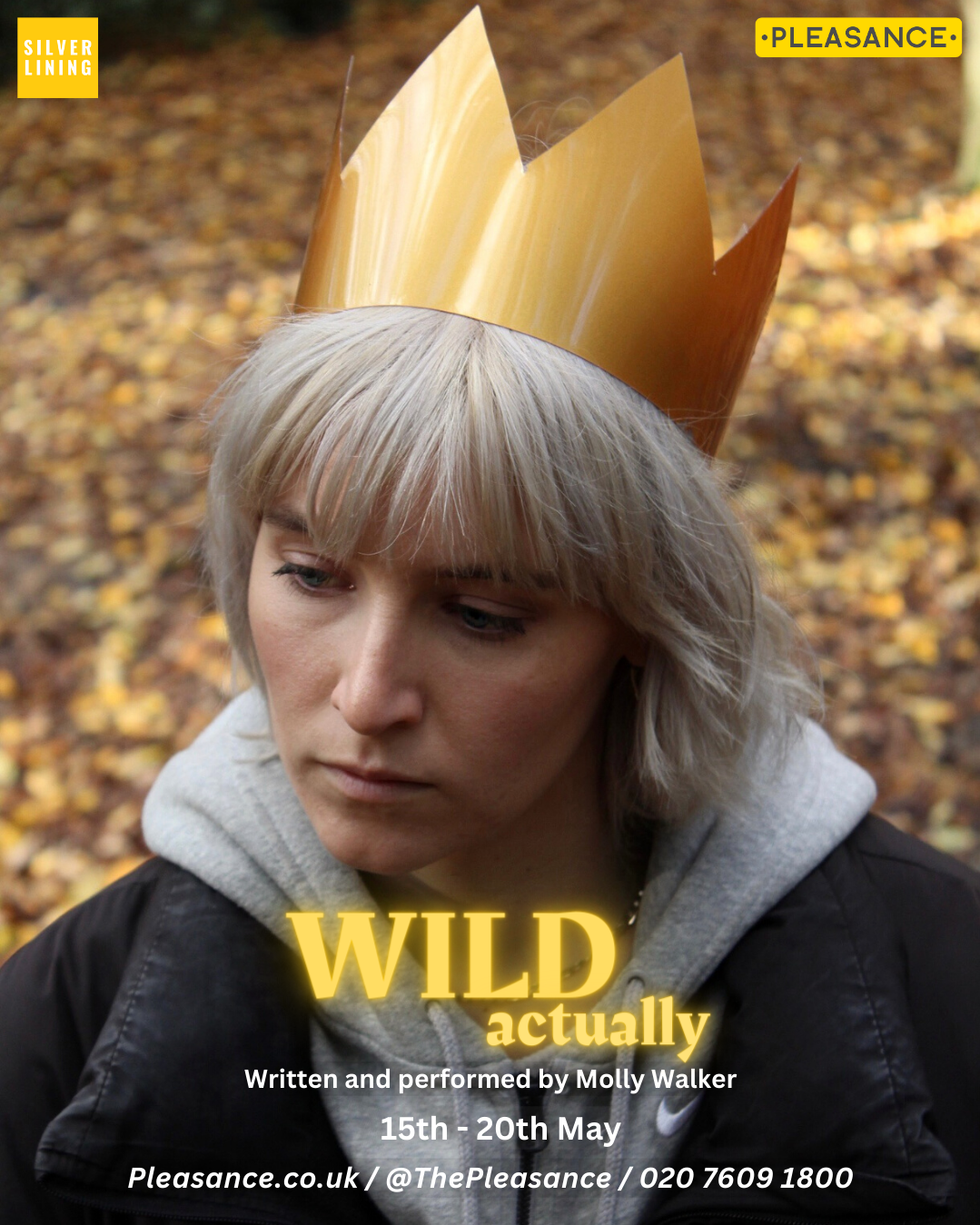 A woman with blonde hair wearing a paper crown poses outdoors with autumn leaves on the ground, promoting a play titled 'WILD actually' by Molly Walker, happening from May 15th to 20th.