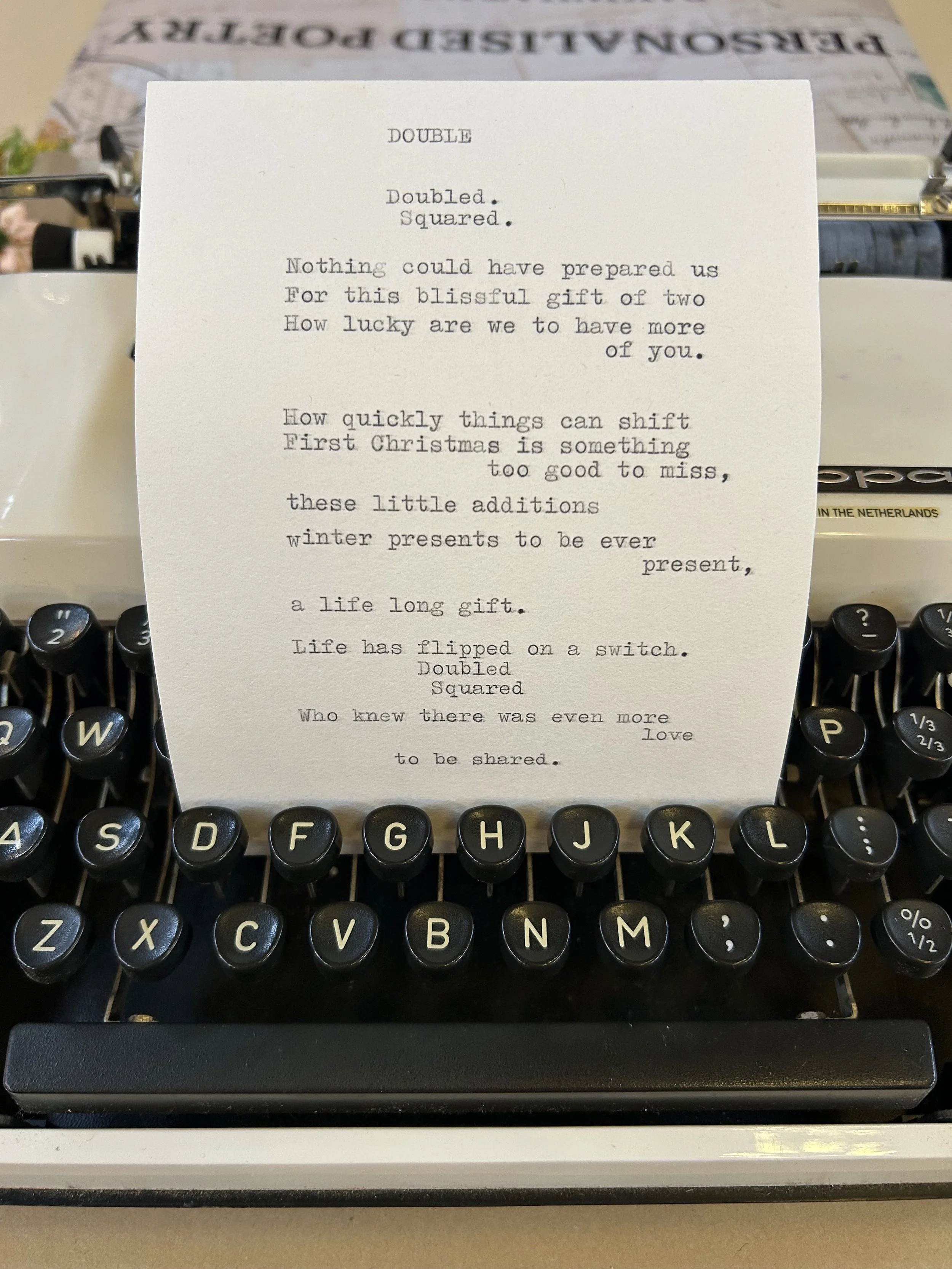 A typewriter with a typed poem on a piece of paper placed on top of it.