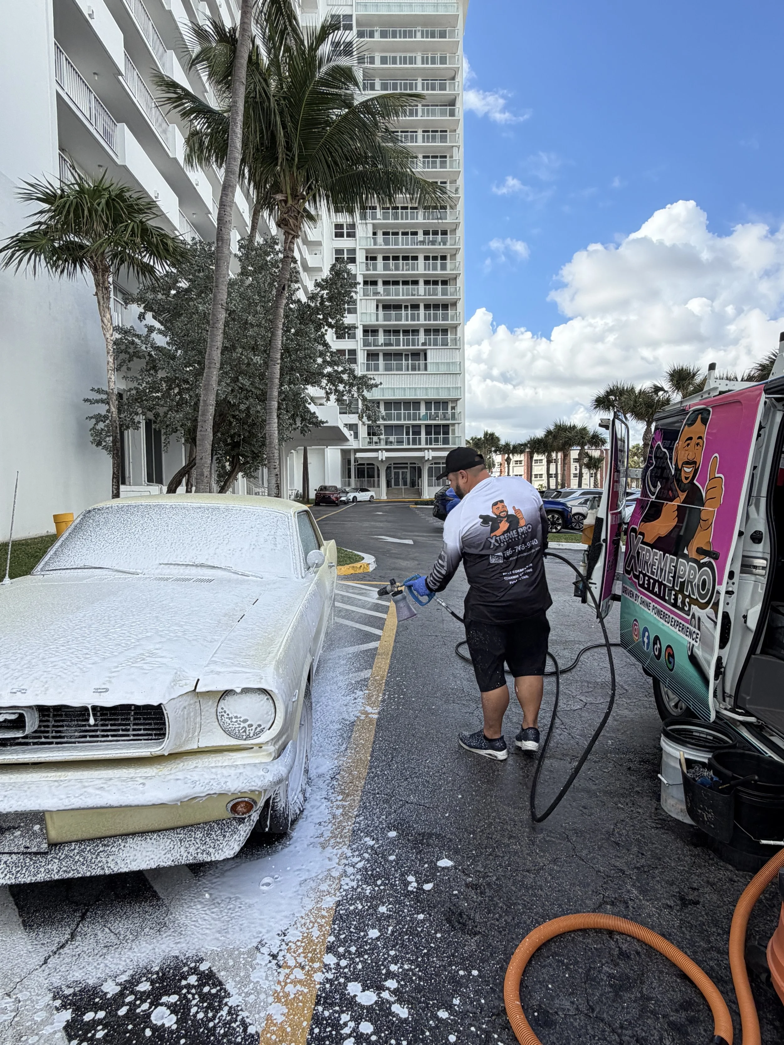 Mobile foam wash service using a foam cannon during an exterior car detailing appointment in Miami-Dade and Broward County.