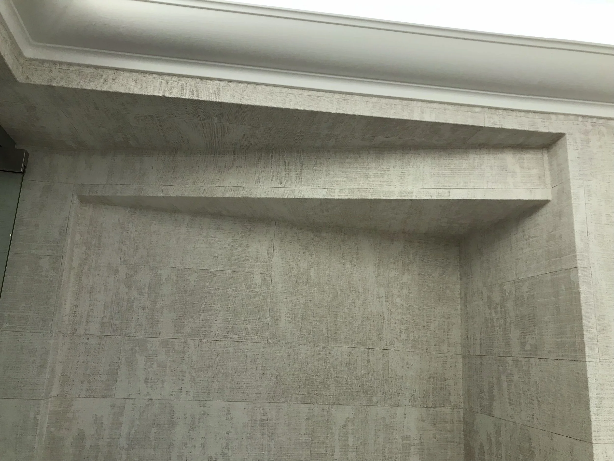 Precision finishing on complex architectural details and recessed niches, requiring meticulous cutting and exact material placement.