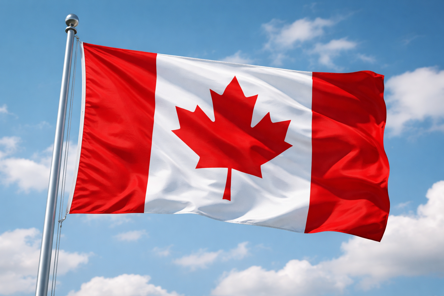 Canadian flag with red and white colors, featuring a red maple leaf in the center, waving against a blue sky with scattered clouds.