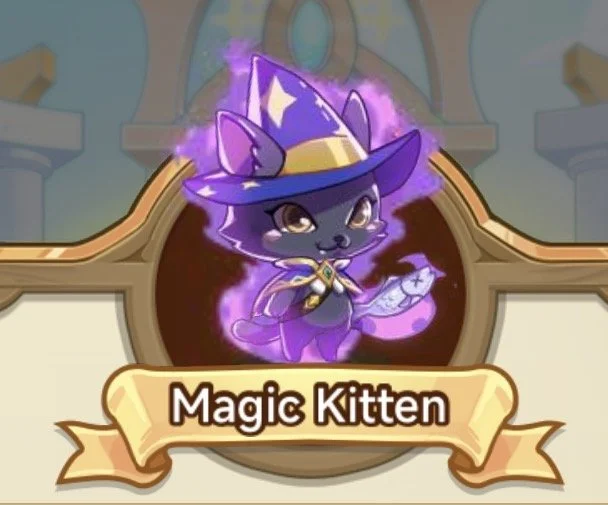 Cartoon illustration of a cute dark gray kitten dressed as a wizard, wearing a purple wizard hat and cloak, holding a magic staff, surrounded by a magical aura. Beneath the kitten is a banner that says "Magic Kitten."