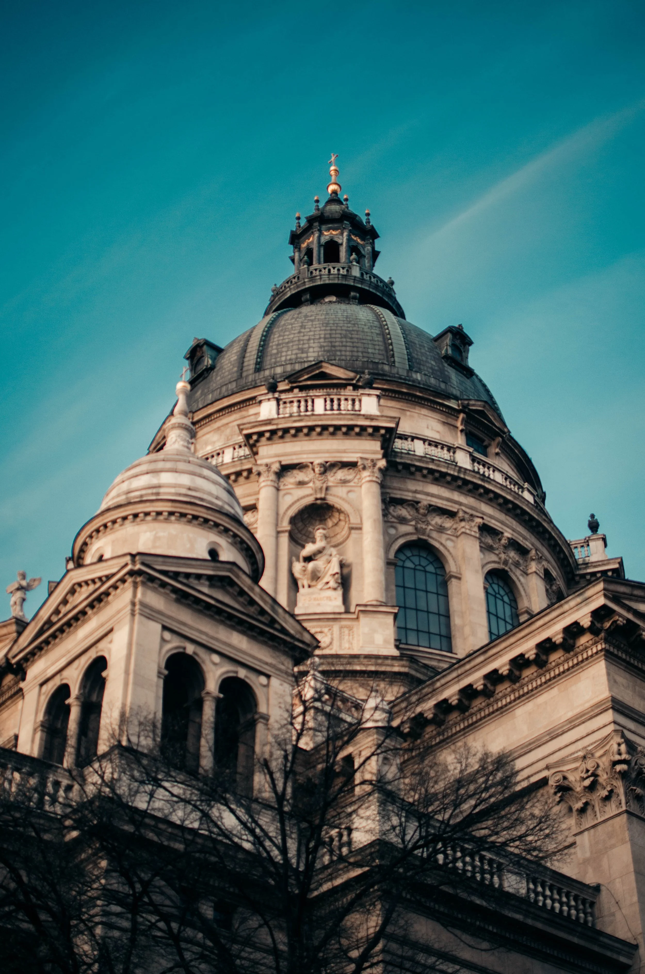 Close-up of a historic church or cathedral with a large dome and ornate architectural details against a blue sky.