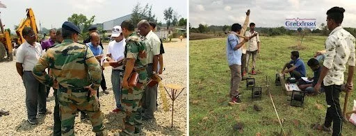Two groups of people outdoors, one on the left with military personnel and civilians, and one on the right with civilians, some sitting and some standing, in an open field with equipment around.