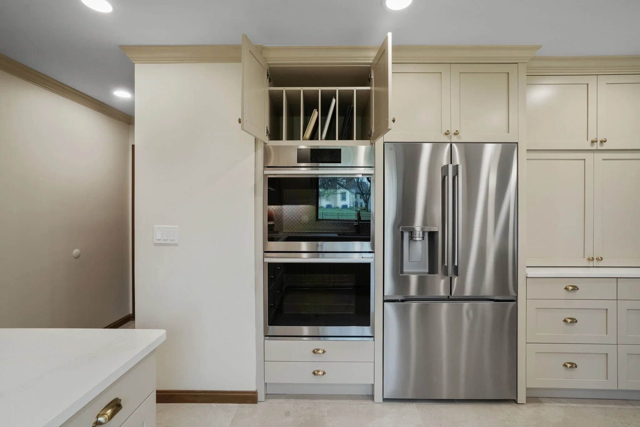 Modern kitchen with built-in double oven and a stainless steel refrigerator.