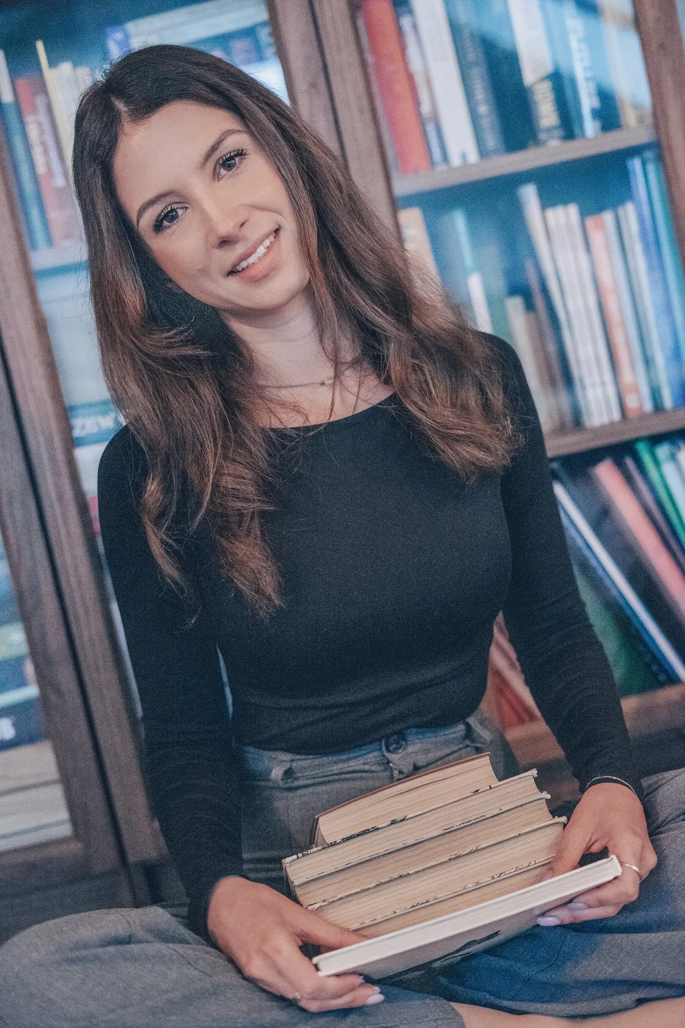 Weronika with a stack of Polish books