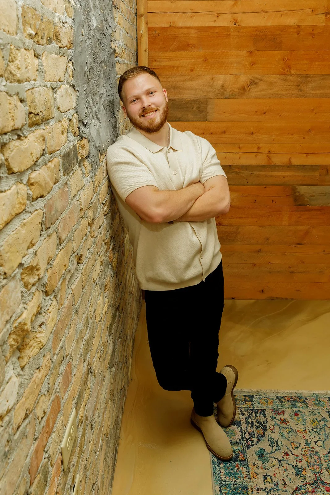 Matthew Rabe, founder of Kingdom Training, smiling with arms crossed against a brick wall — mindset and identity coach based in Appleton, Wisconsin