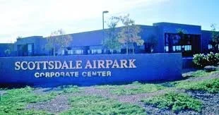 Sign of Scottsdale Airport Corporate Center in front of a blue building