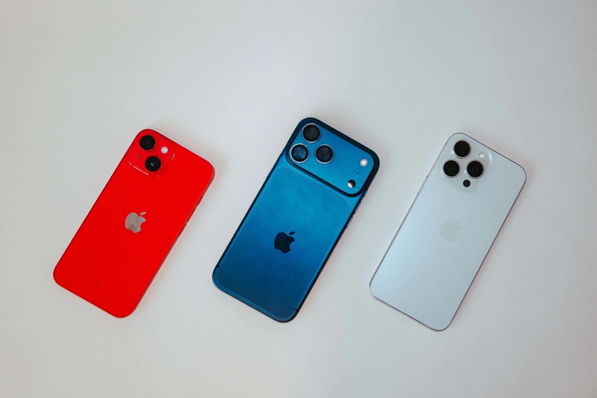 Three Apple iPhones used as tools for content creation, photography, and social media marketing