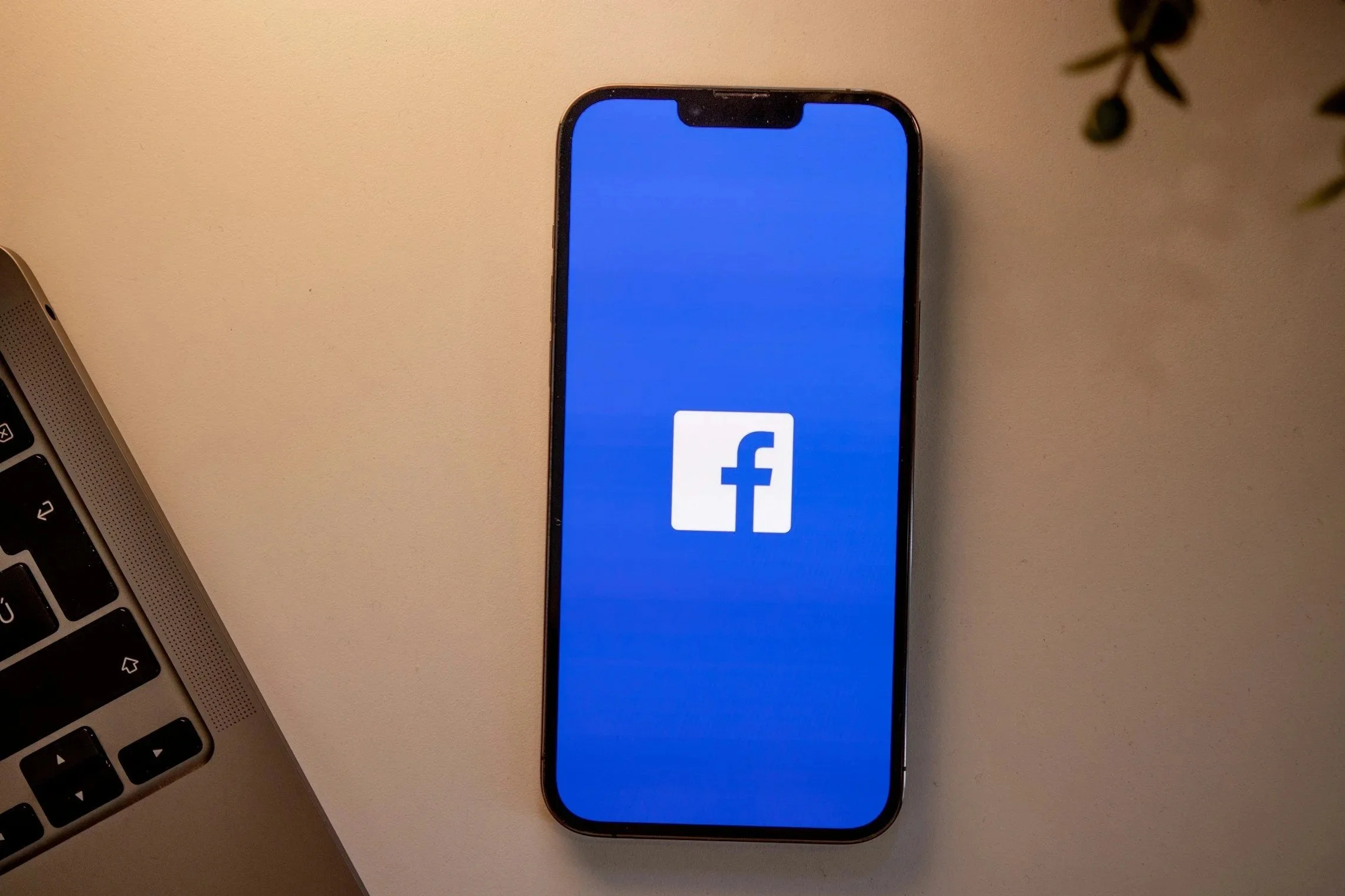 An iPhone displaying the Facebook app logo on the screen, directing to kaelani's facebook- kaelani perez art. Oil painter and multimedia artist, fort smith arkansas