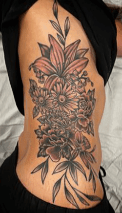 floral-rib-piece-tattoo-black-and-grey.png.webp
