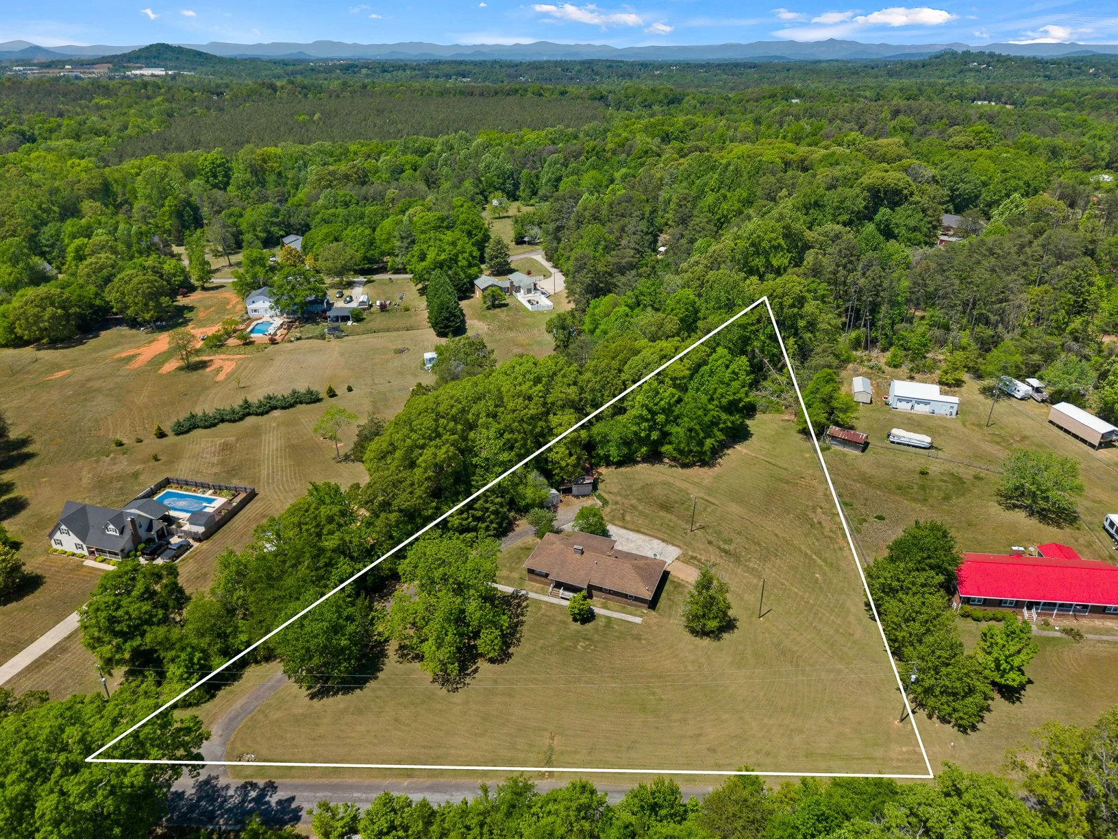 Aerial view showing 2.15-acre homesite, open yard areas, and surrounding rural setting.