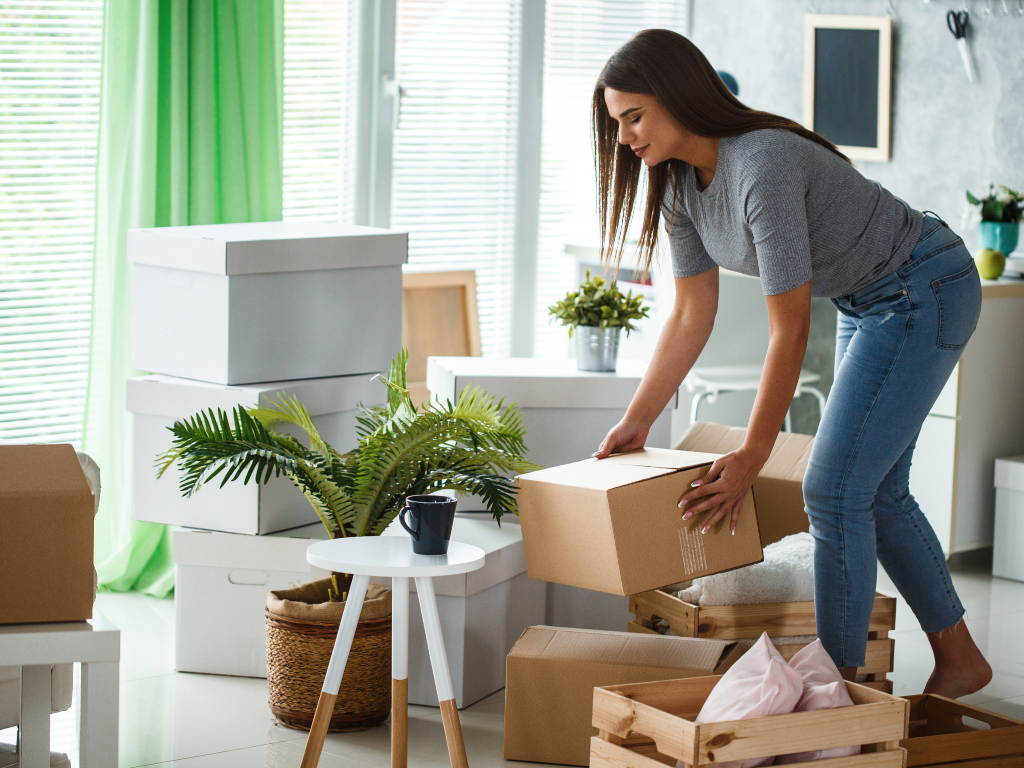 Homeowner unpacking boxes and organizing belongings after moving into a new home