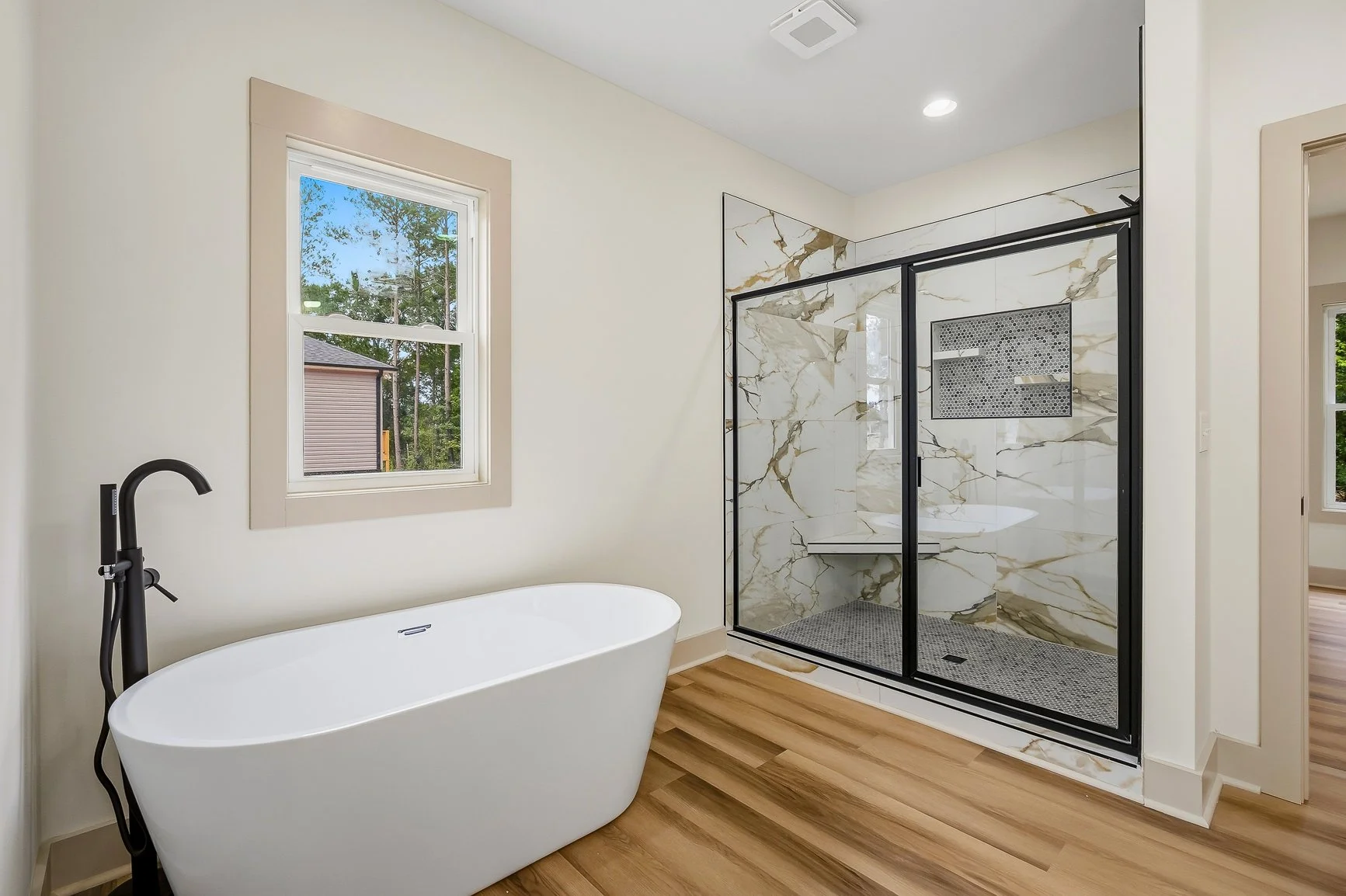 Primary bathroom, free standing modern tub and oversized tiled shower