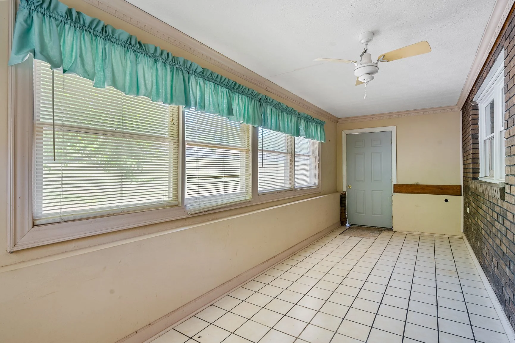 Sunroom overlooking the backyard with additional flexible living space.