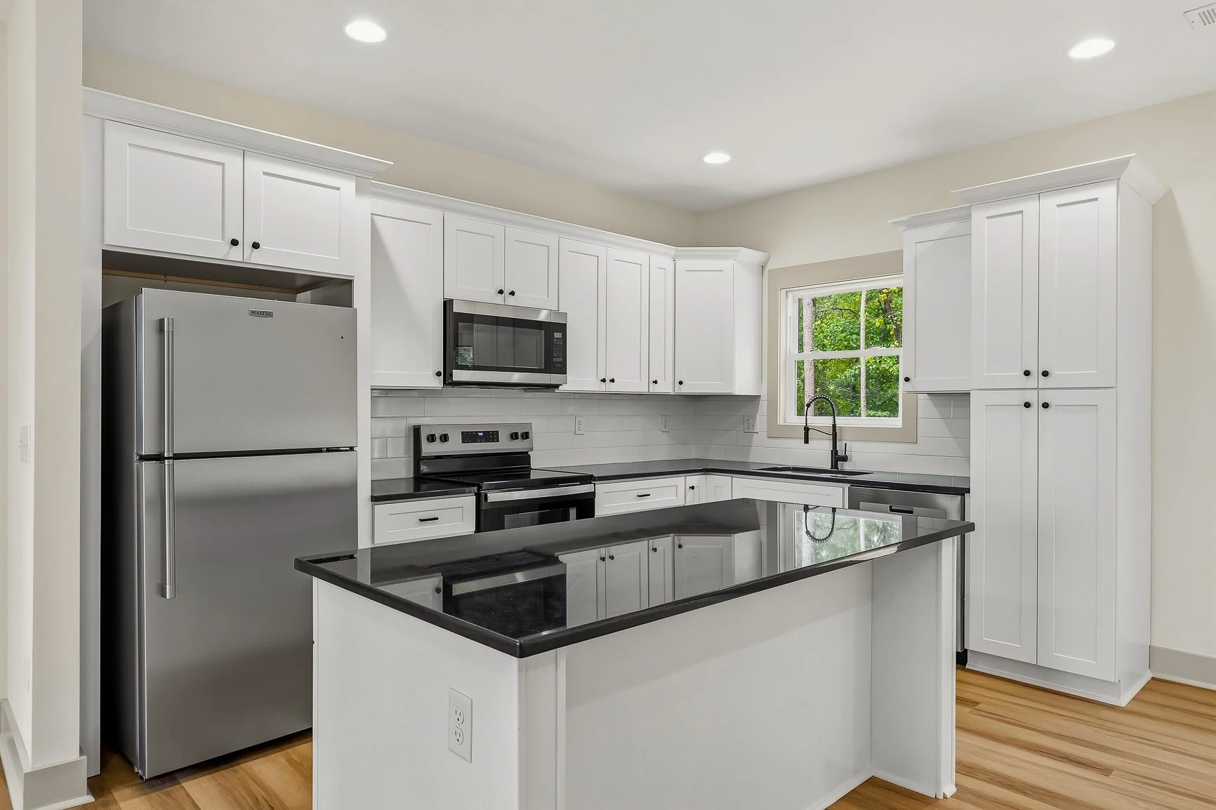 Black granite, kitchen island with seating and outlets