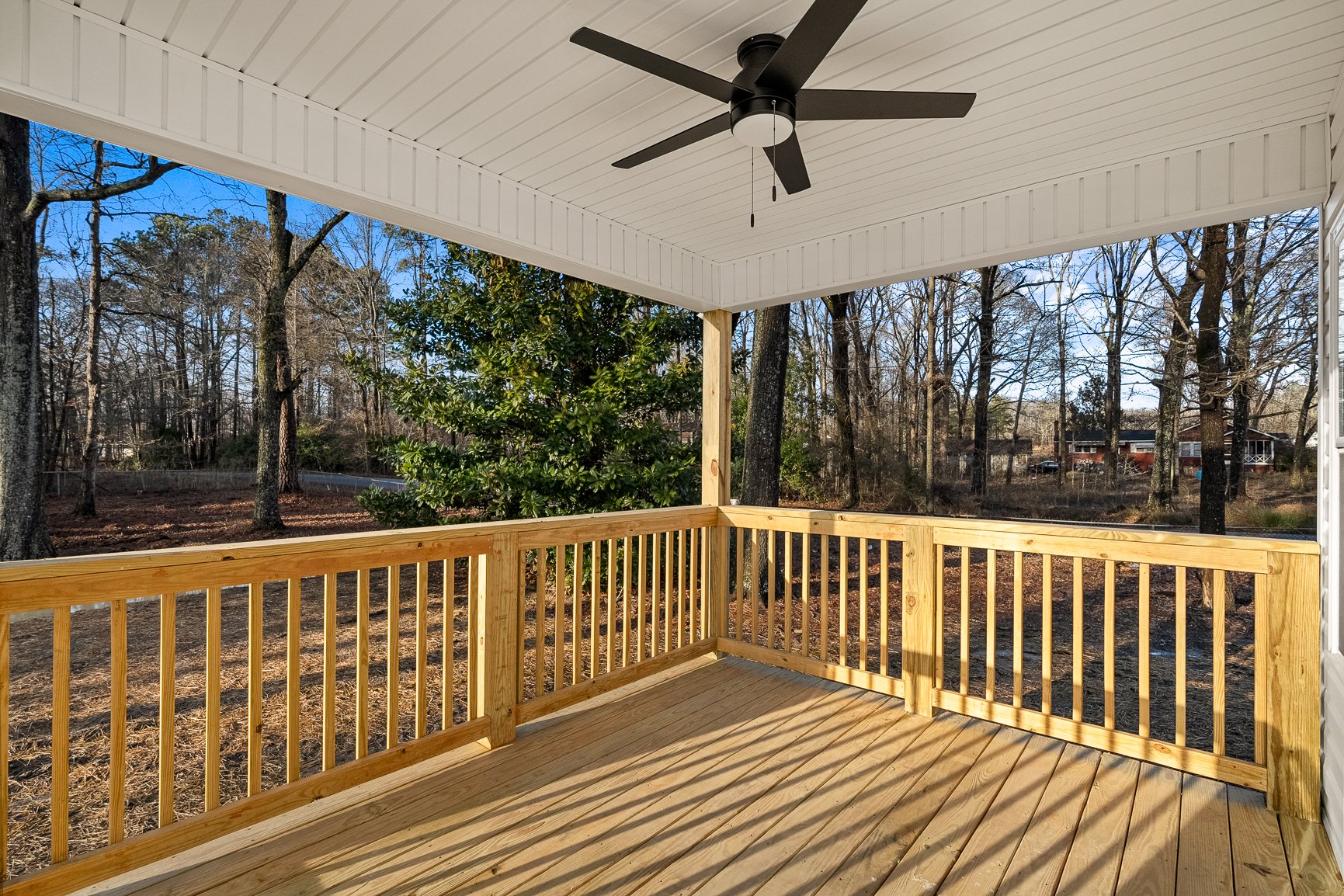 covered deck with ceiling fan back yard
