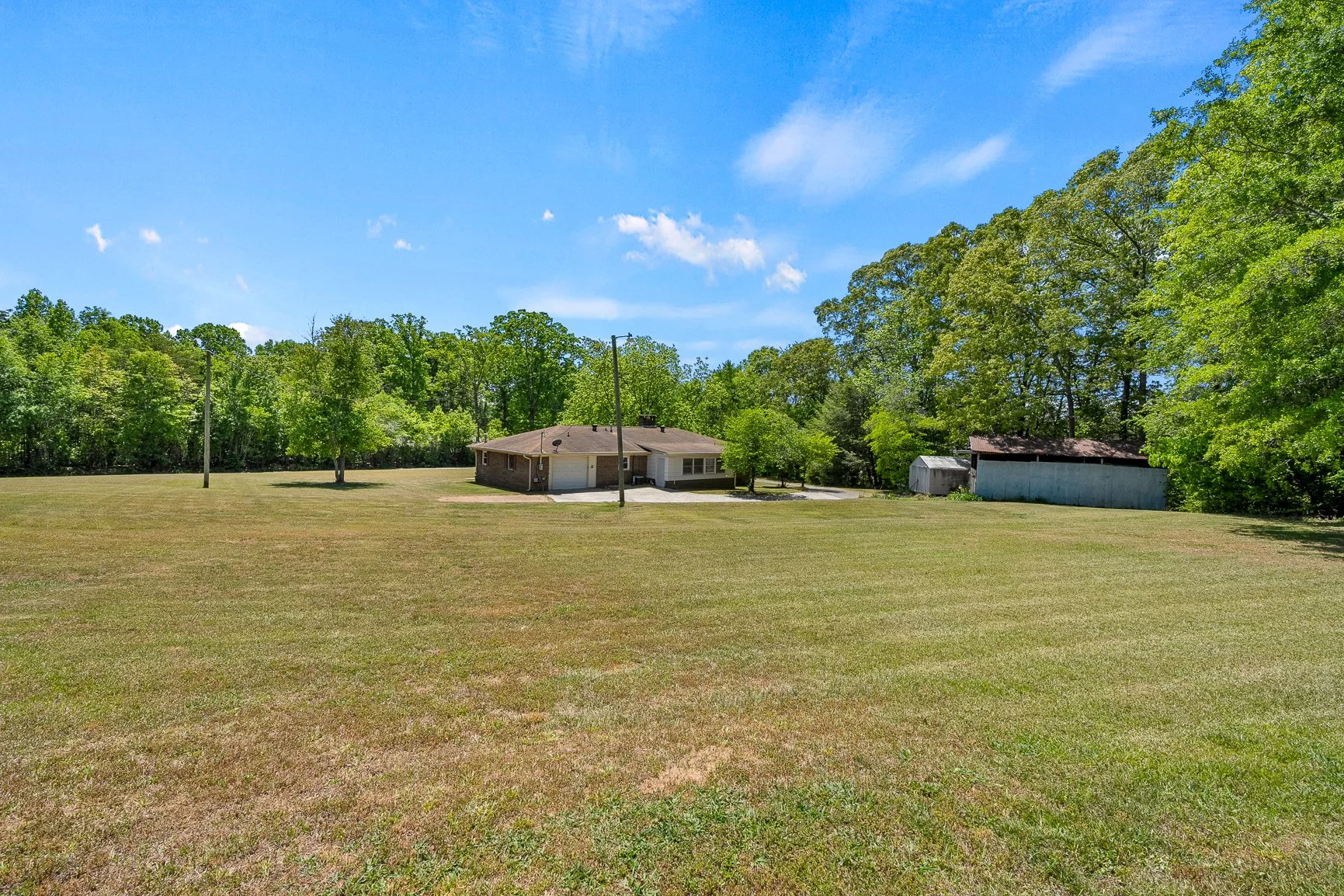 Open lawn and usable yard surrounding the home at 120 Robbie Court.